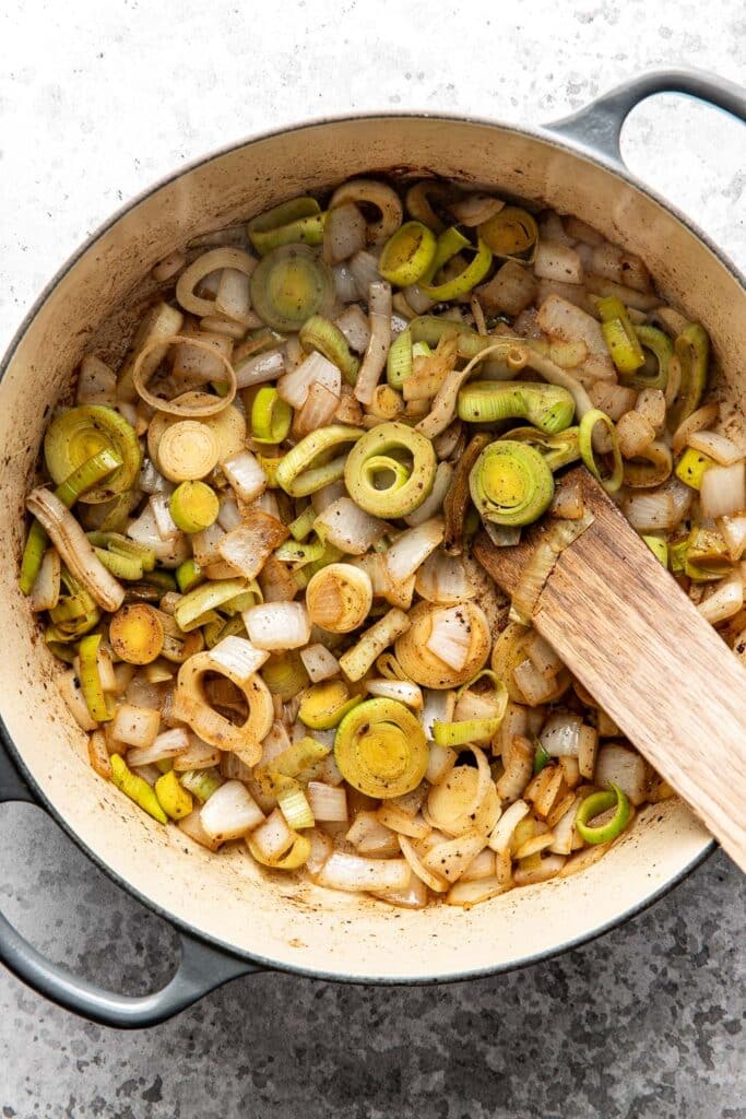 Onions and leeks cooking in a dutch oven