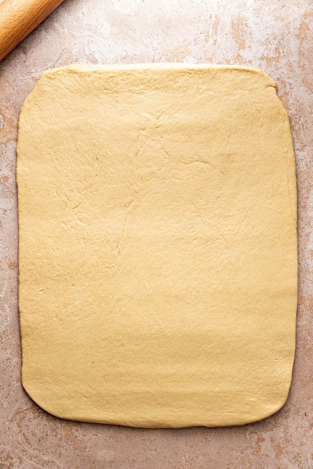 cinnamon roll dough rolled out into an 18x24 rectangle