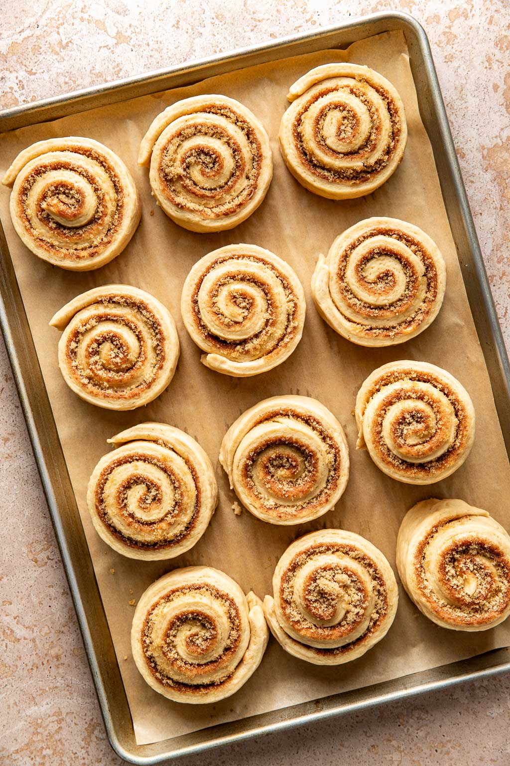 cinnamon rolls on a baking sheet before baking