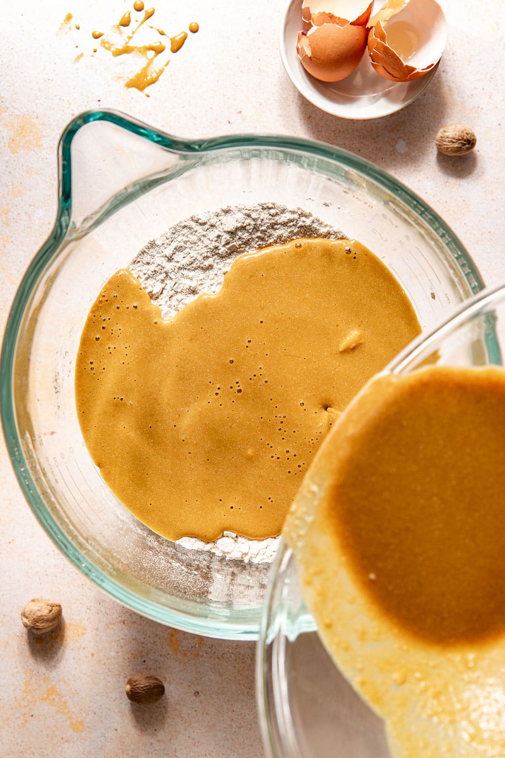 wet ingredients being poured into the dry