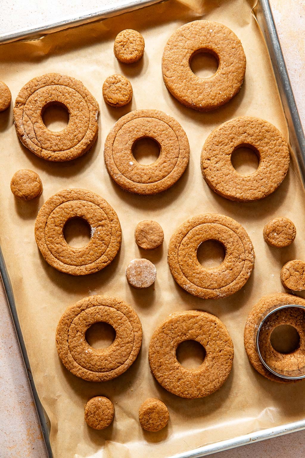 donuts before frying on a baking sheet