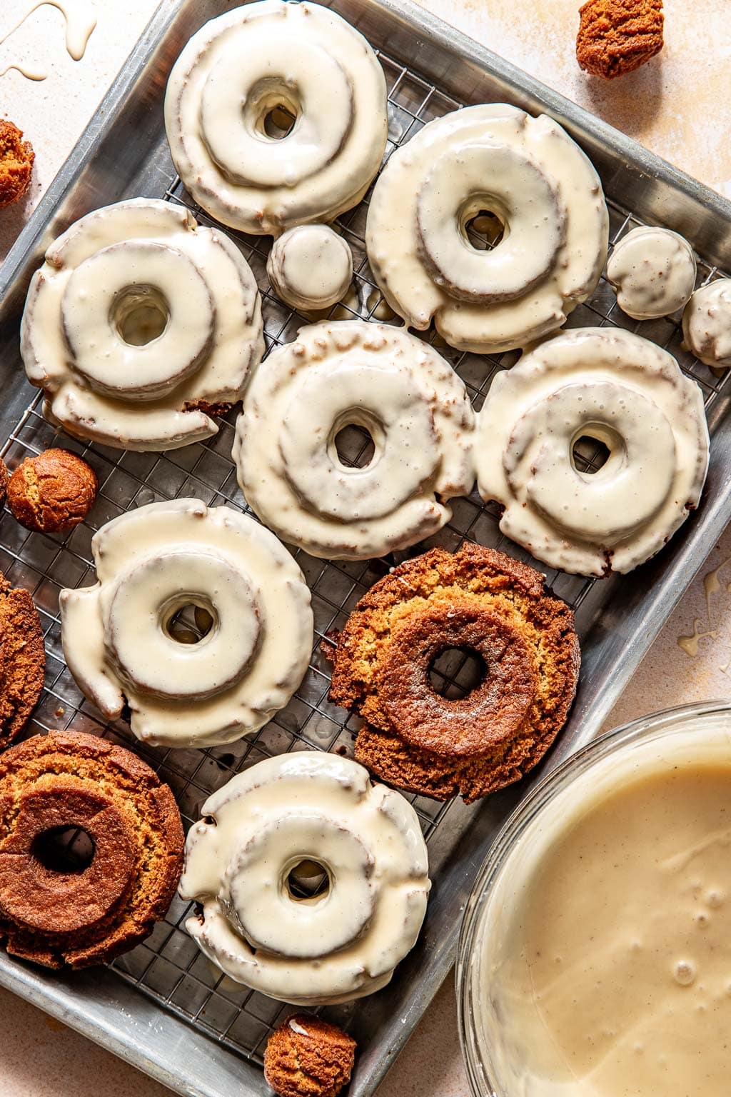 donuts on a baking sheet, half of them glazed