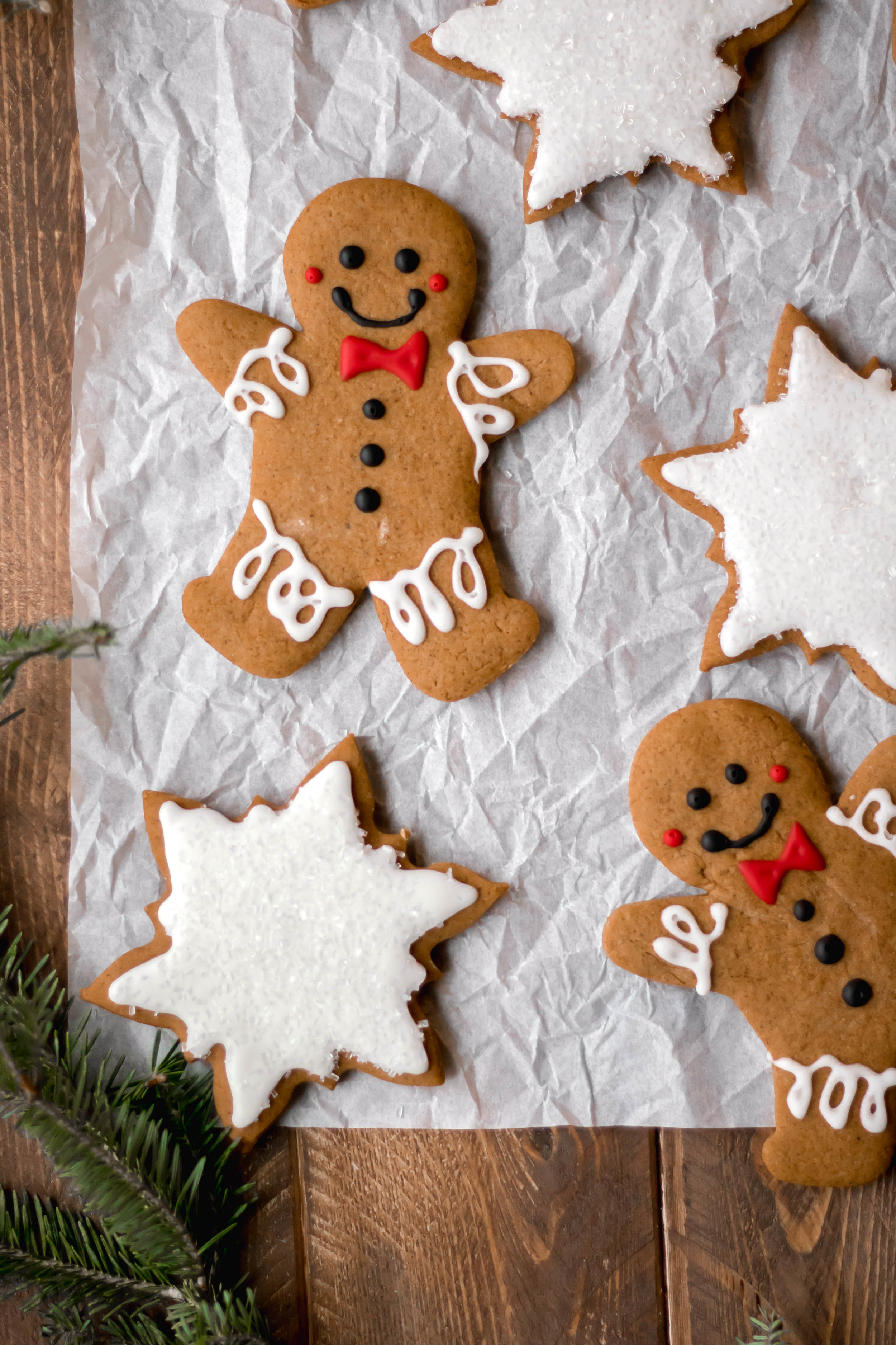 Various frosted gingerbread cookies on parchment paper 