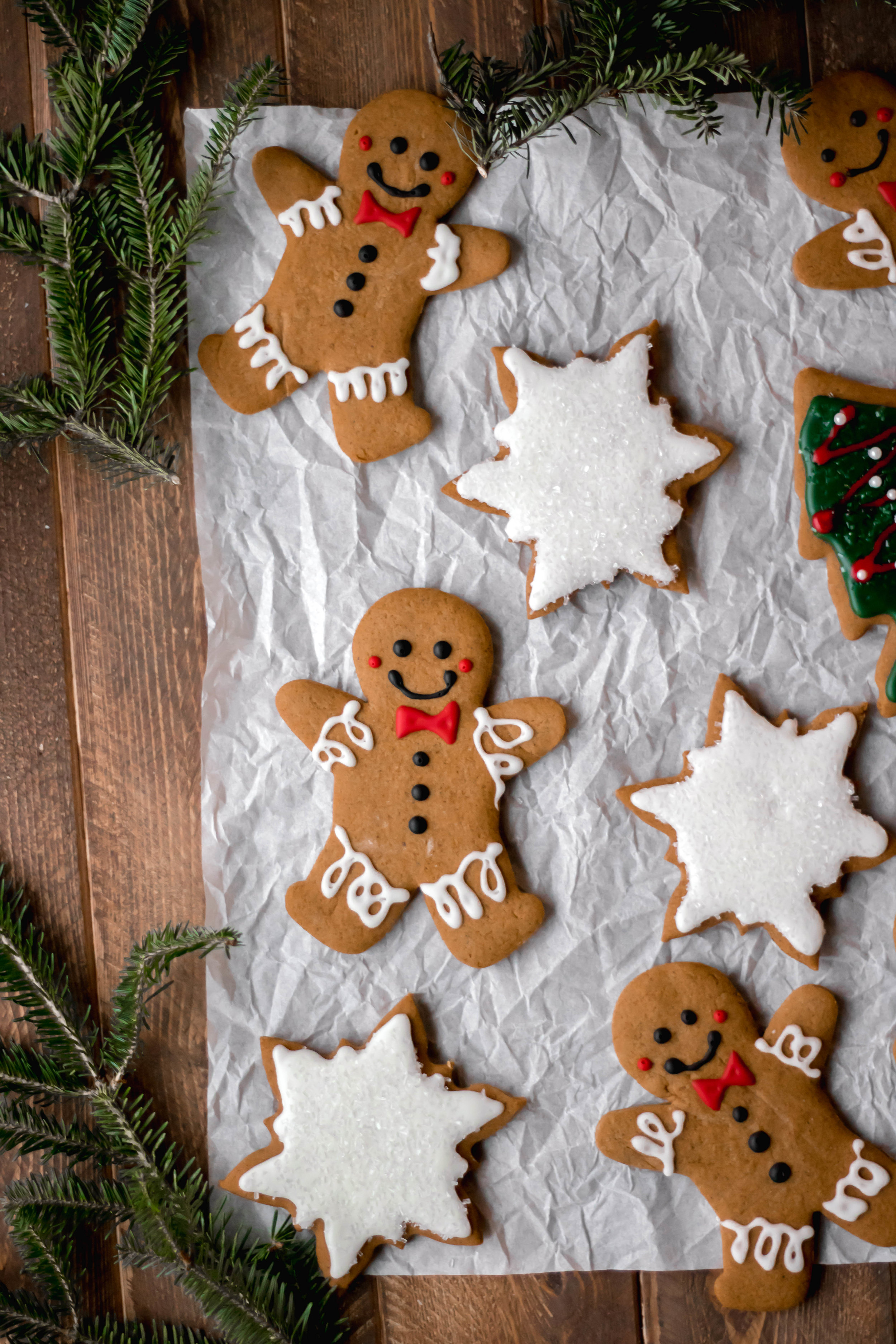 Various frosted gingerbread cookies on parchment paper 
