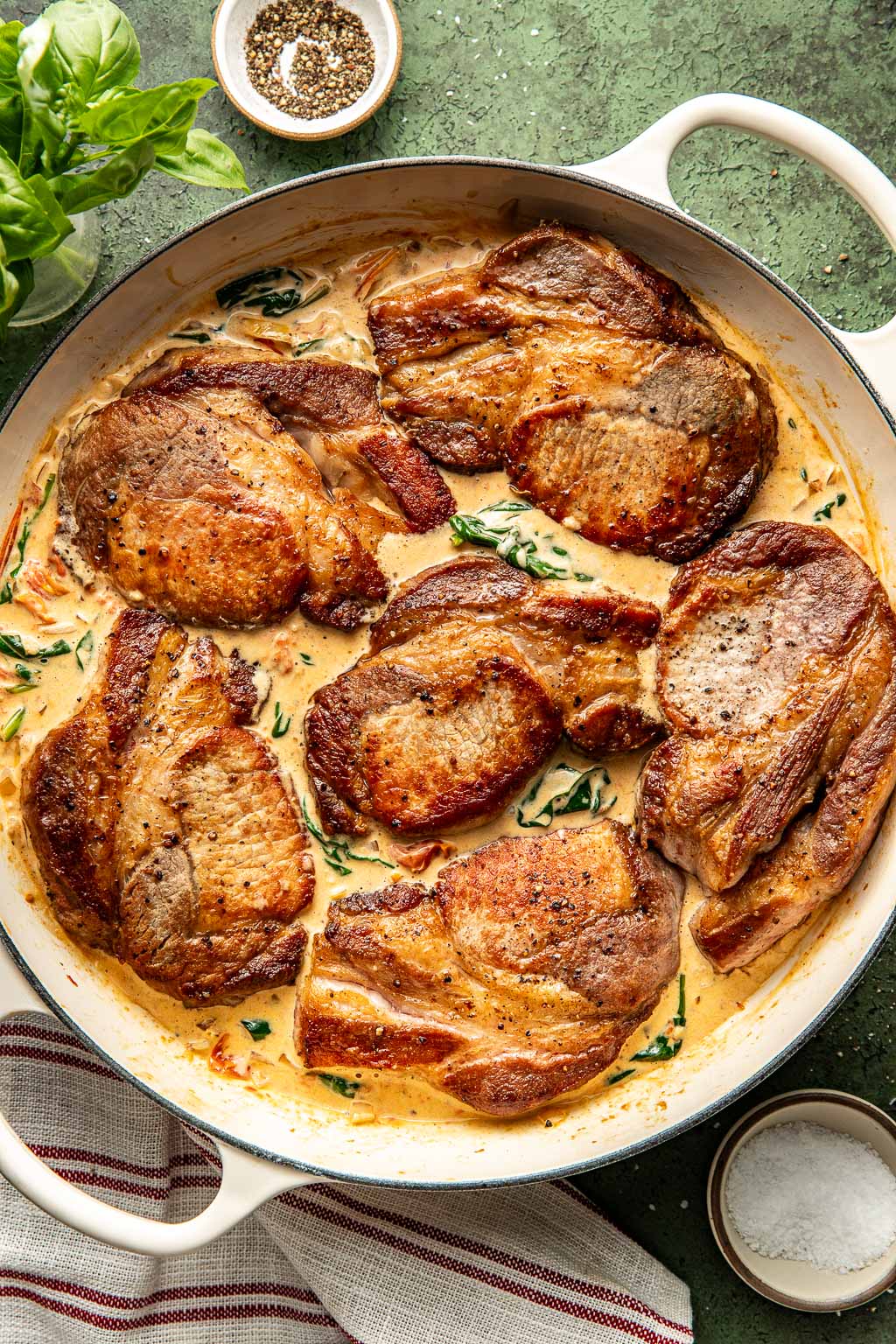 Pork chops in the florentine sauce before going into the oven