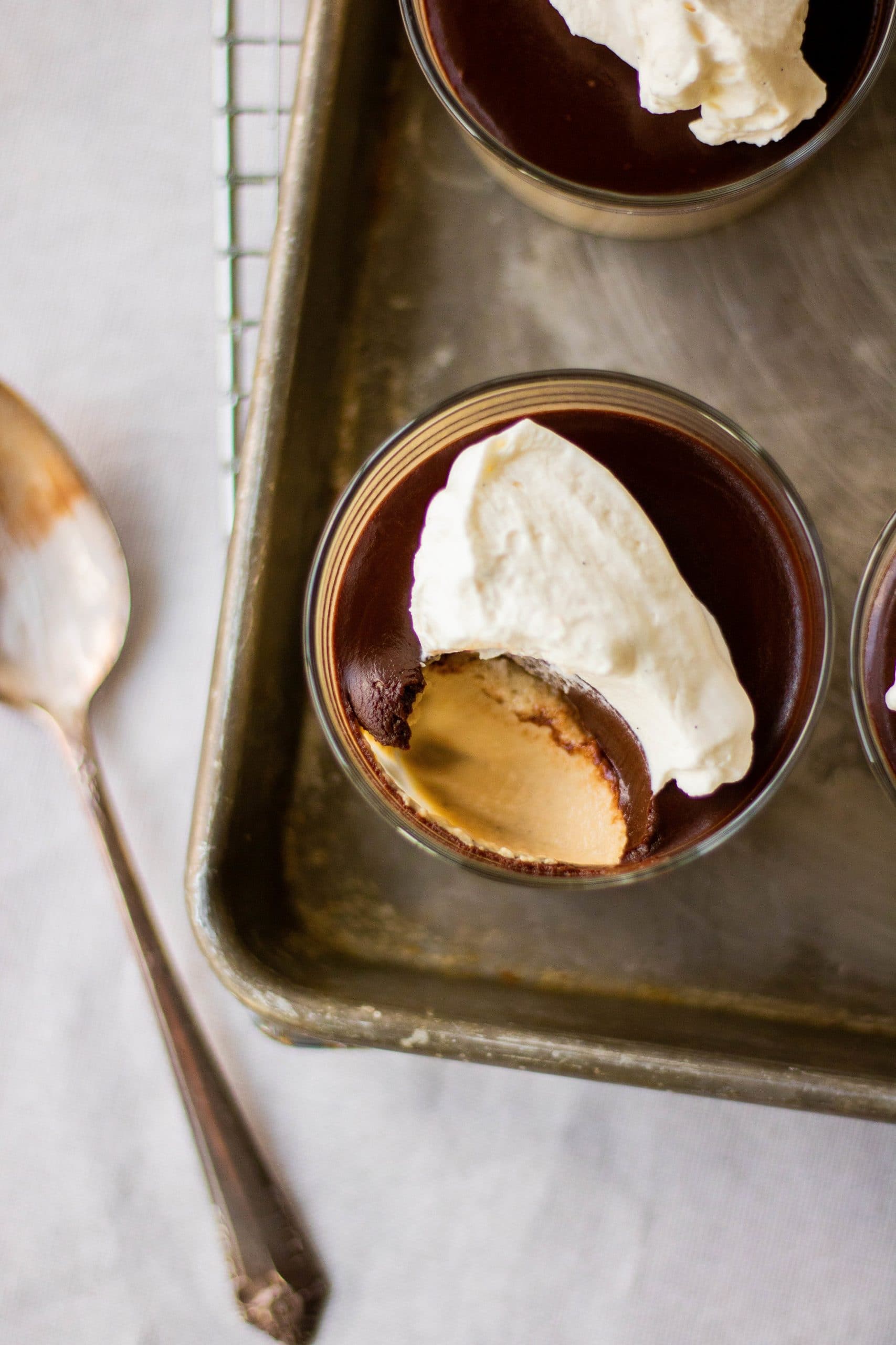Overhead view of coffee panna cotta topped with chocolate ganache and mascarpone whipped cream. 