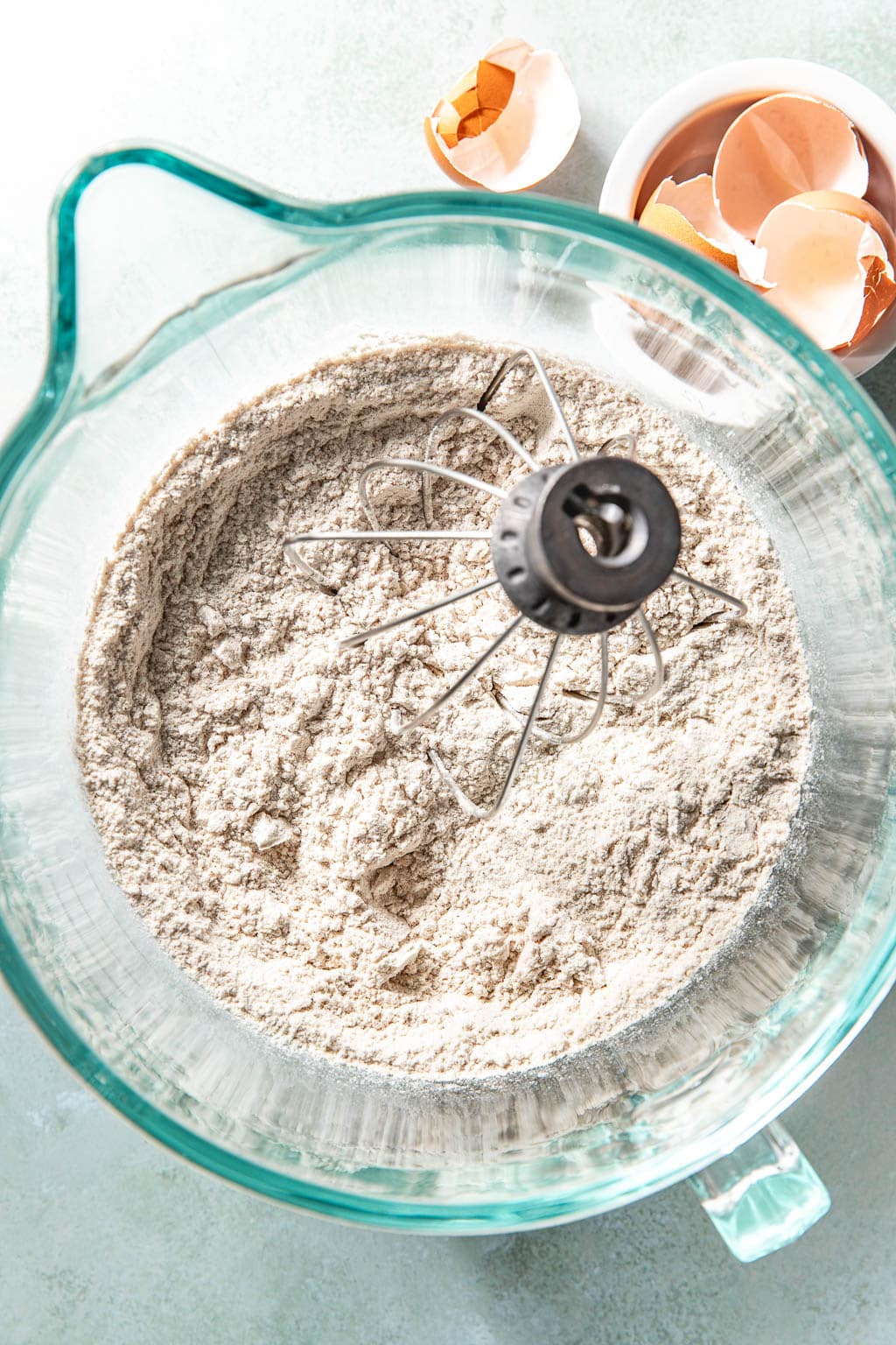 dry ingredients for carrot cake donuts in a mixing bowl