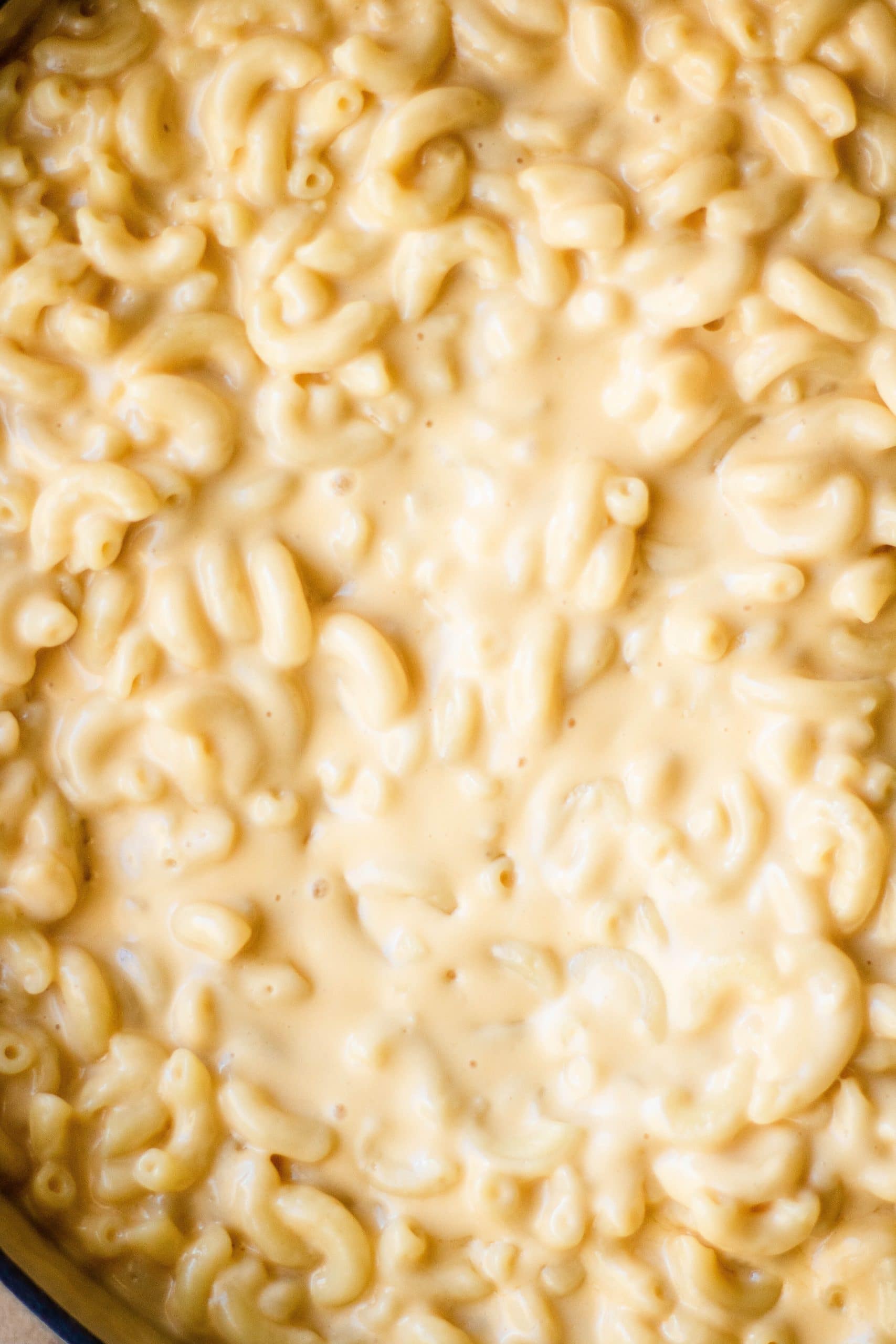A closeup of creamy mac and cheese made with evaporated milk 