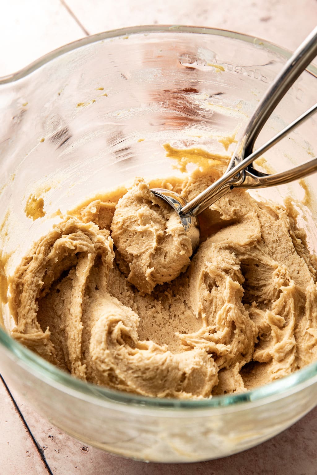 cookie scoop sitting in the cookie dough after mixing