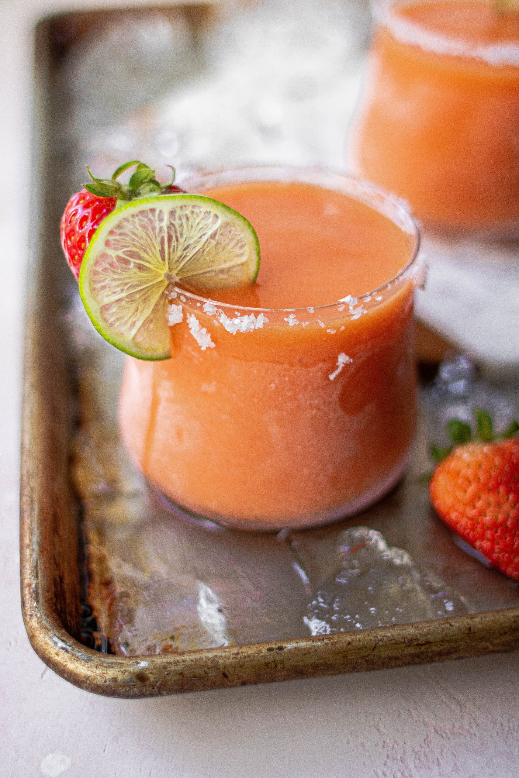 a blended strawberry mango margarita rimmed with salt 