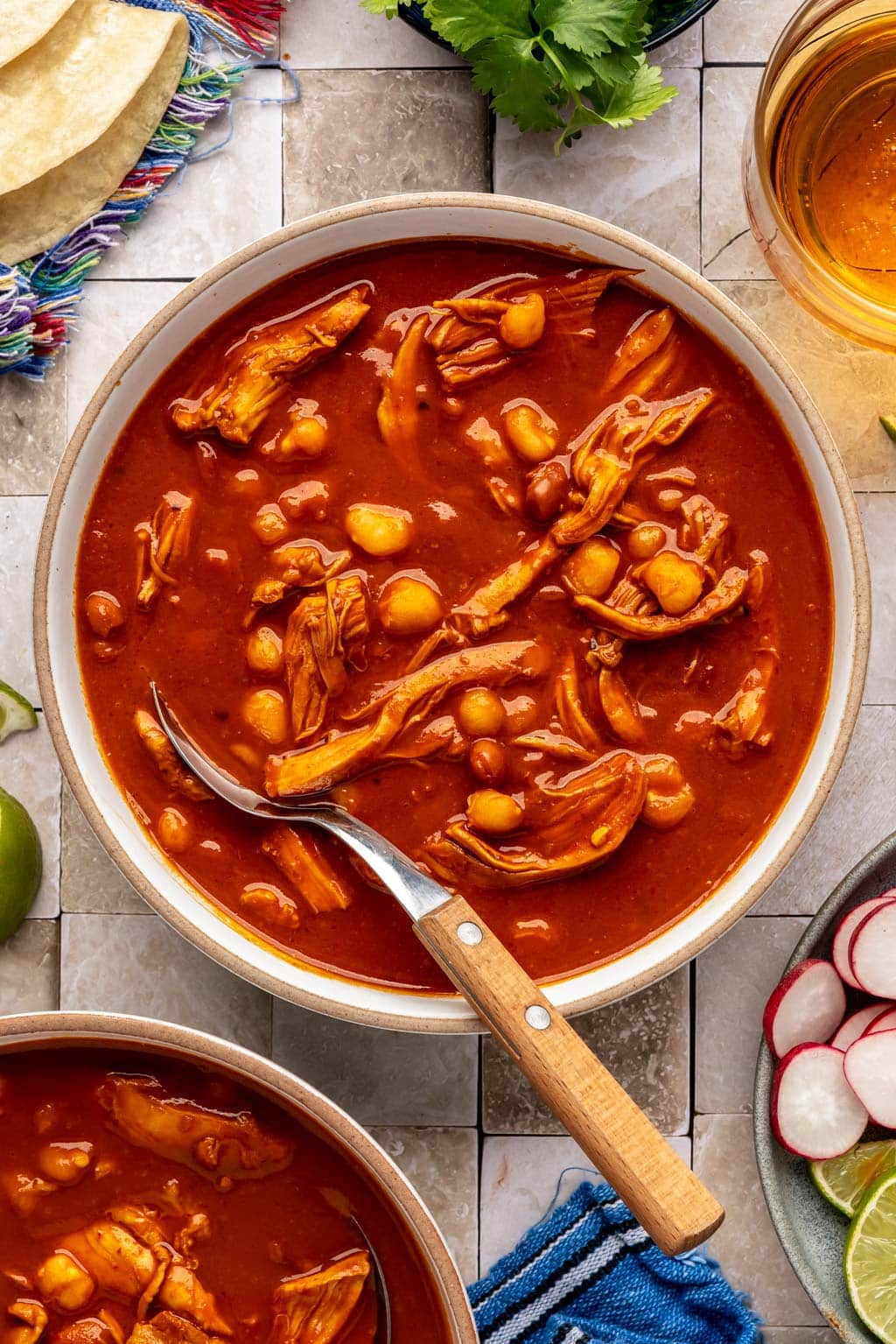 red chicken pozole in a bowl 