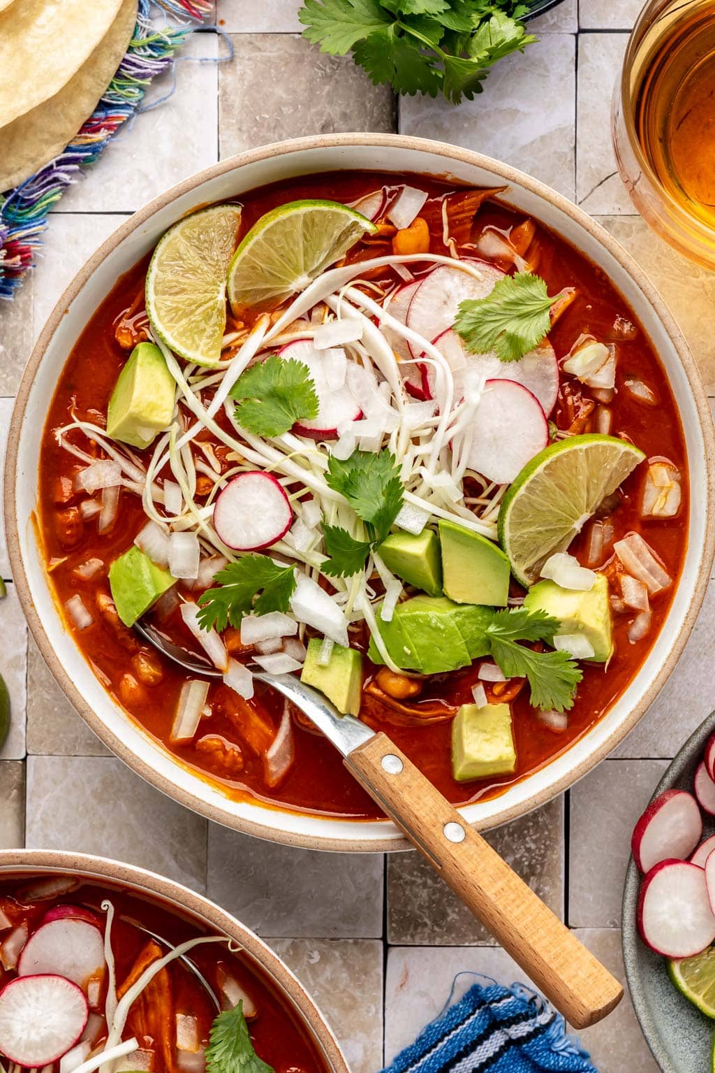 chicken pozole topped with shredded cabbage, radish, lime, and avocado 