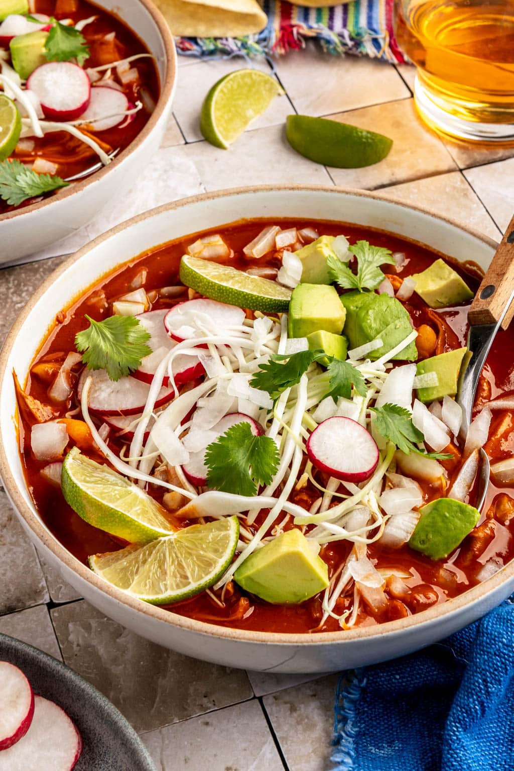 chicken pozole topped with shredded cabbage, radish, lime, and avocado 