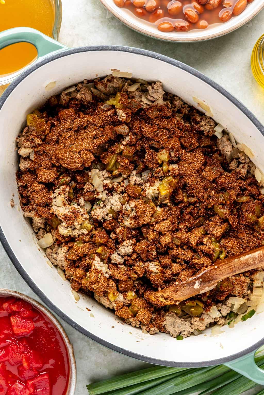 ground turkey and spices in an oval dutch oven