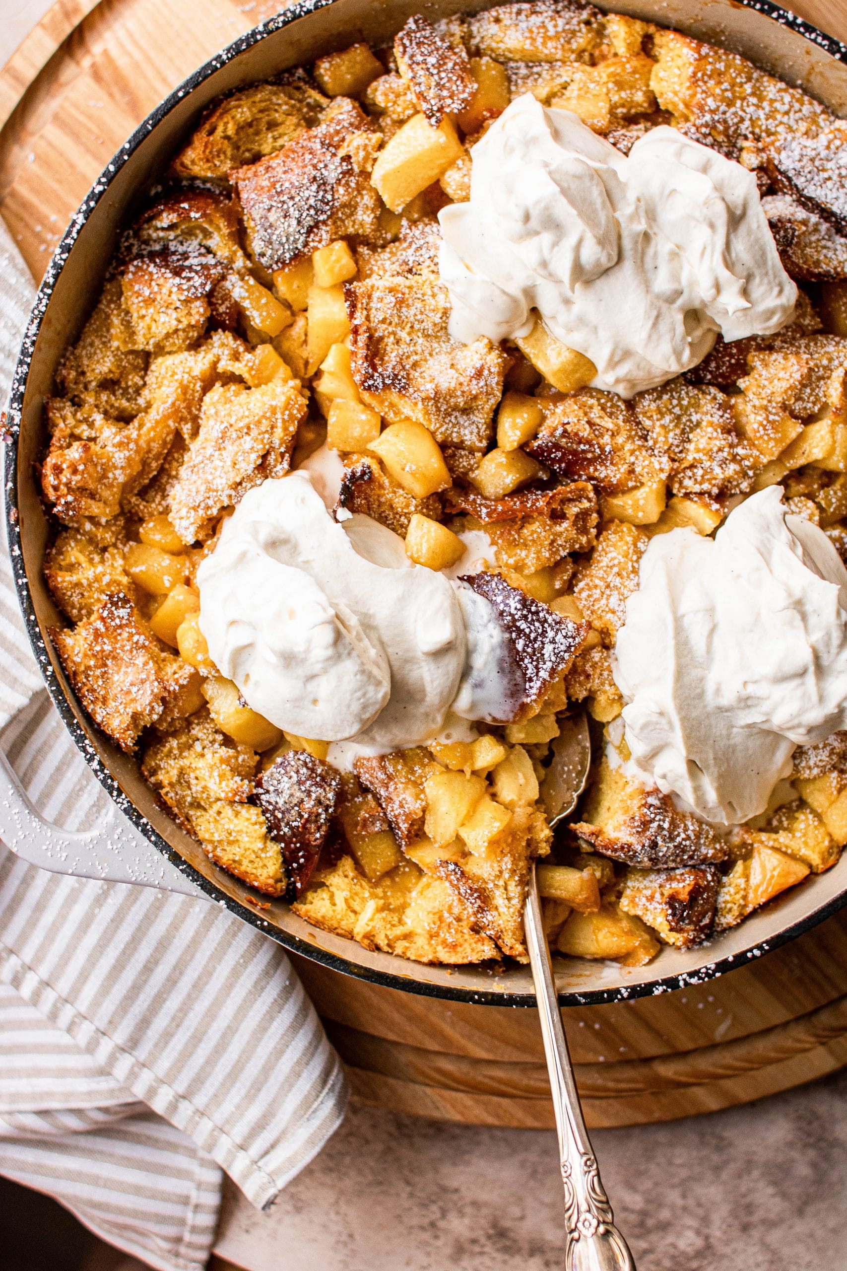 Apple pie french toast casserole topped with maple whipped cream