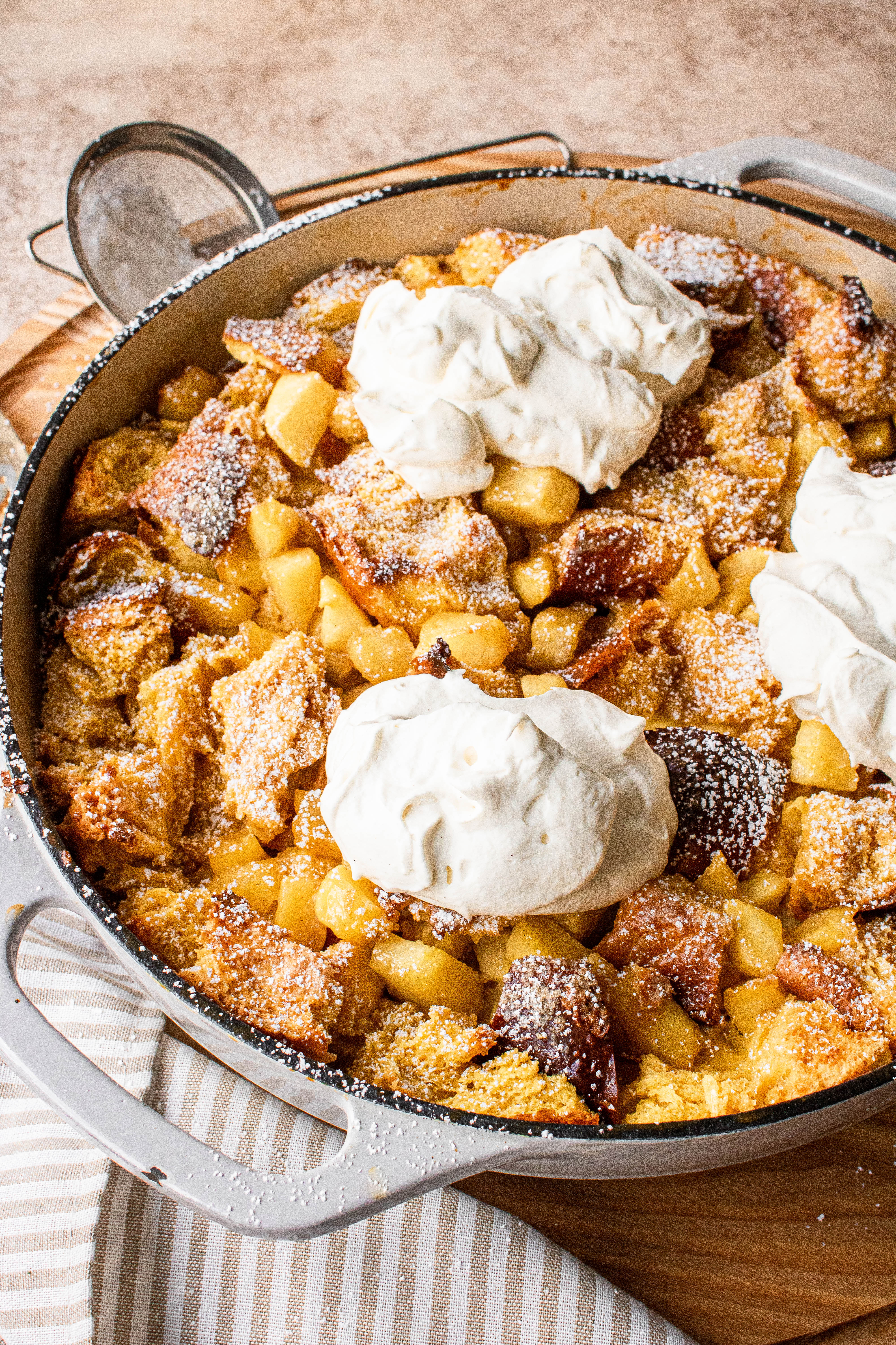 Apple pie french toast casserole topped with maple whipped cream