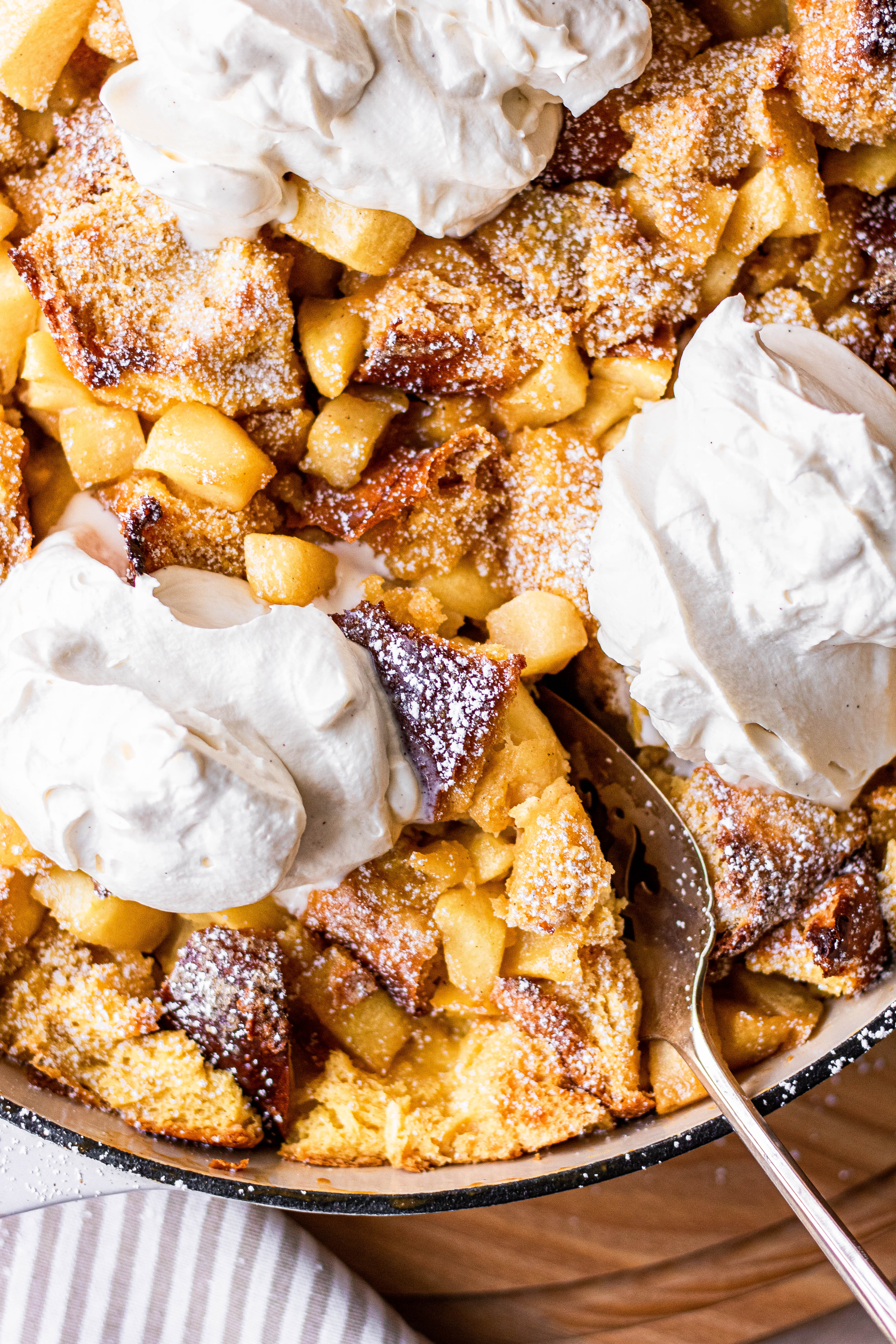 Apple pie french toast casserole topped with maple whipped cream