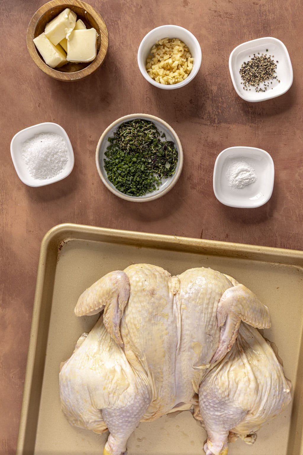 Herb roasted spatchcock chicken ingredients laid out