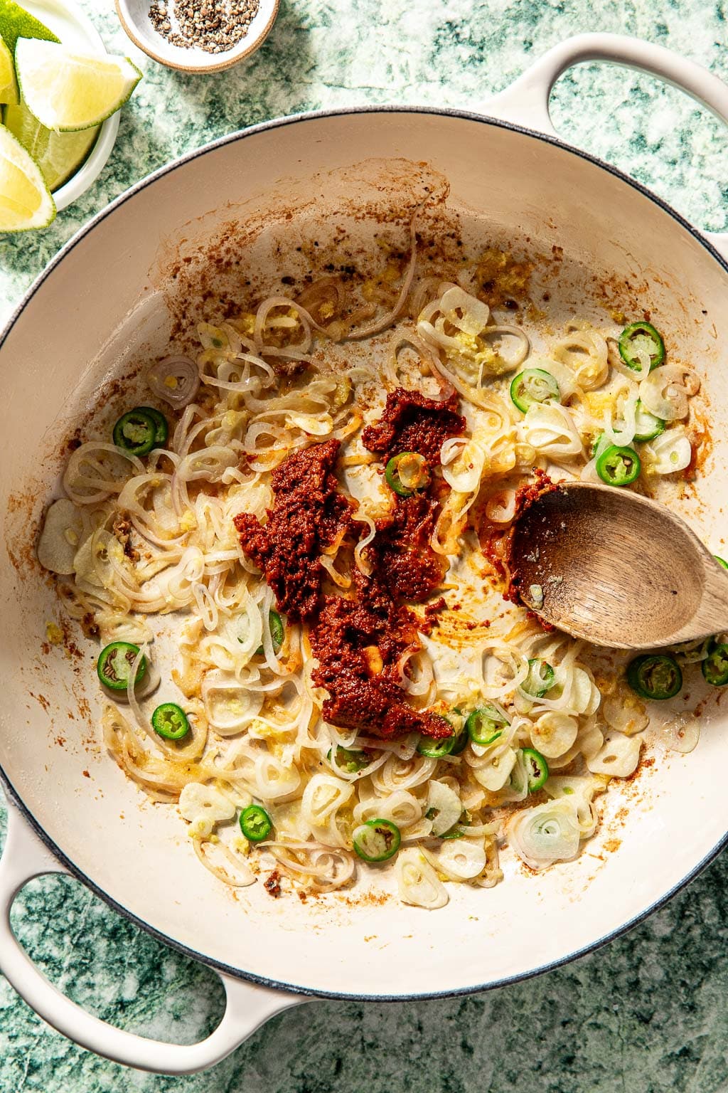 curry paste and aromatics in a braiser