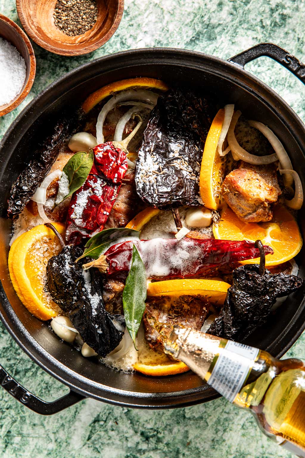 beer being poured into the dutch oven