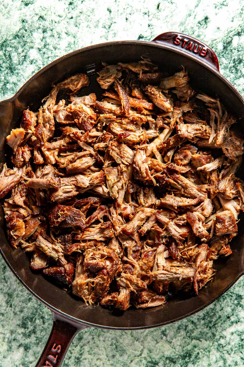 crispy carnitas in a cast iron skillet