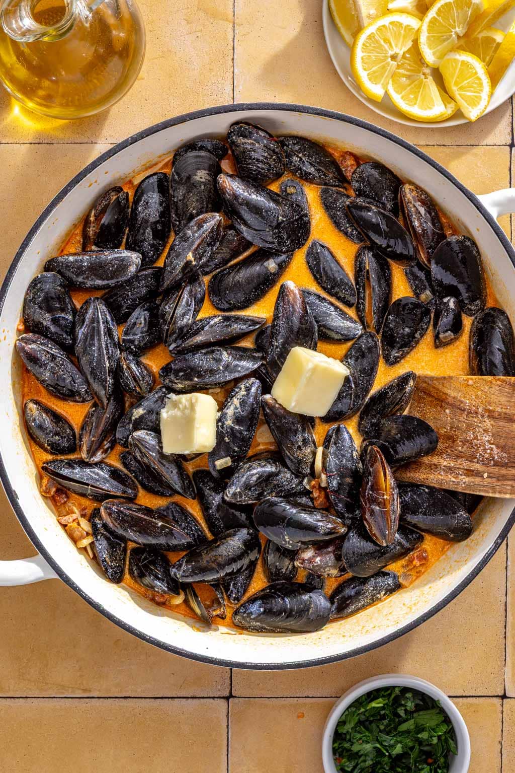 Mussels and butter in the chorizo broth before steaming