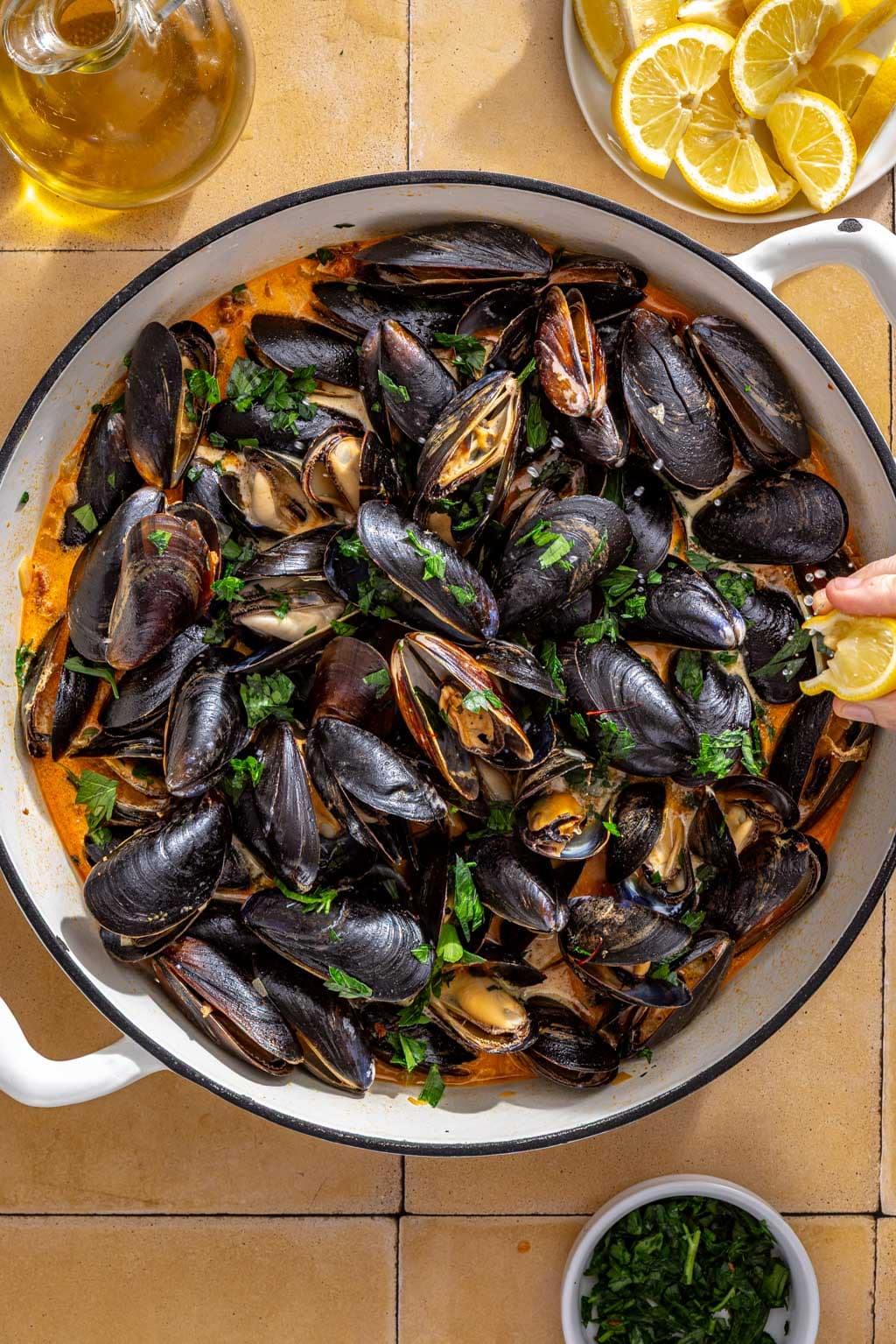 Mussels after steaming, topped with parsley and lemon