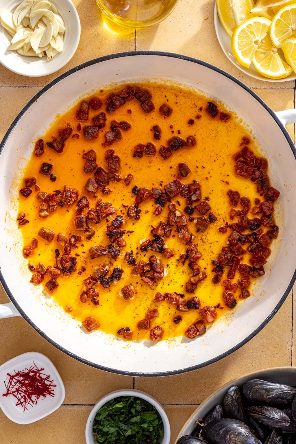 Chorizo rendering in a braiser