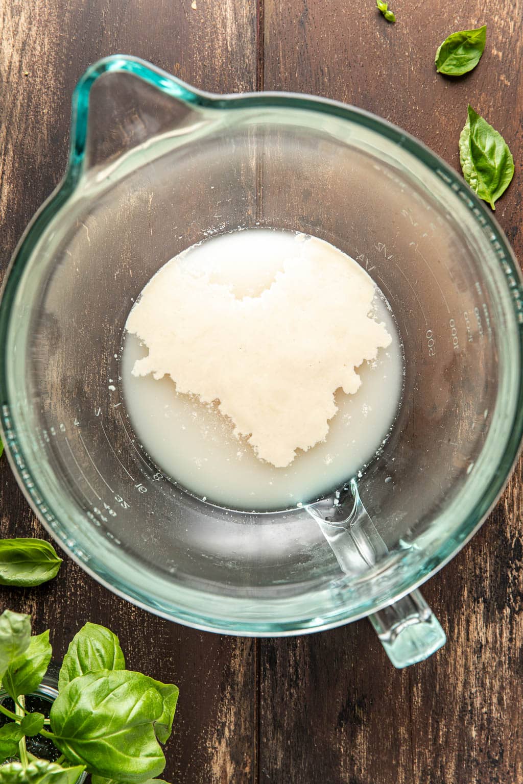 Foamy yeast and water in a mixing bowl