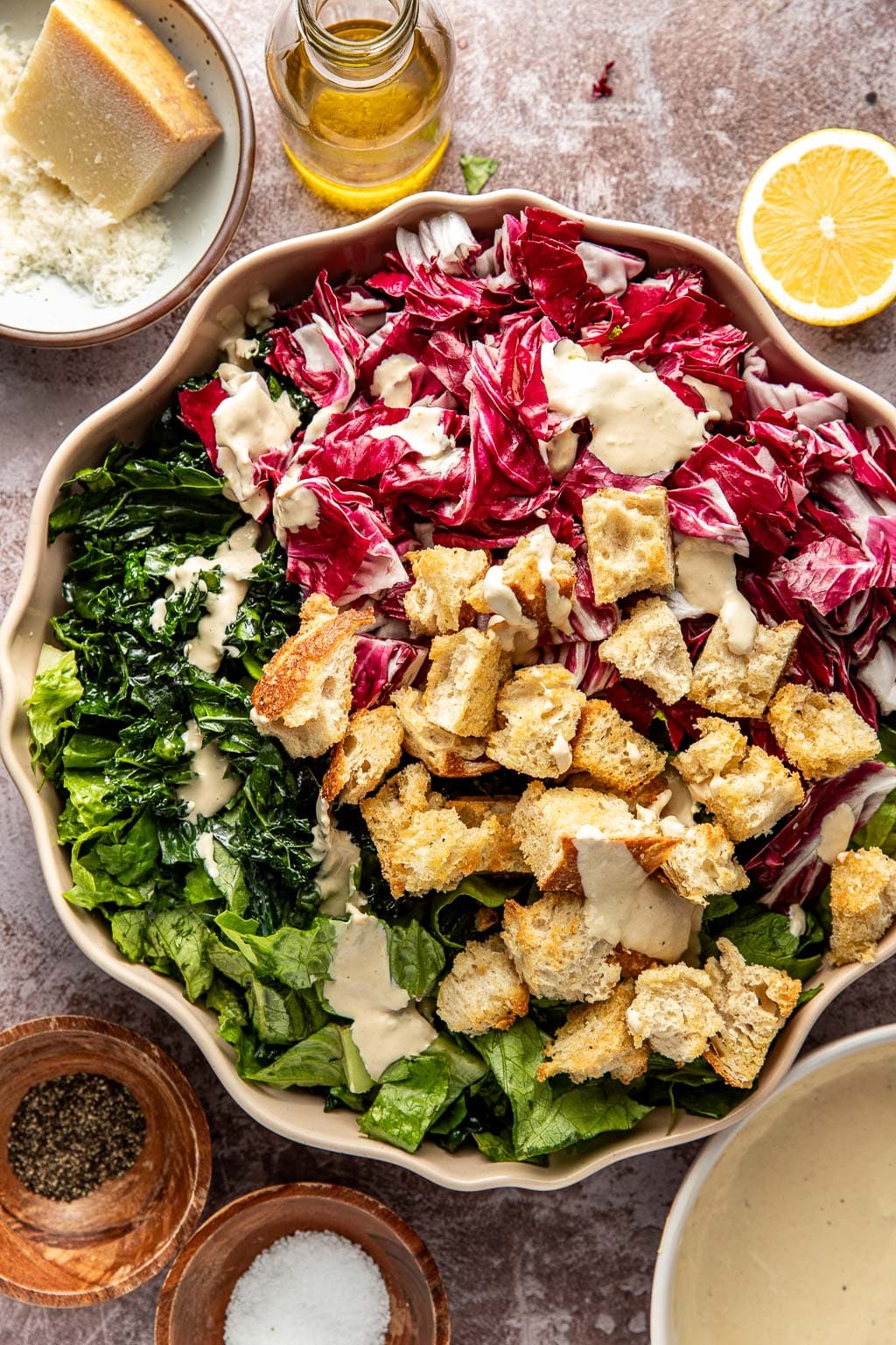 kale caesar salad ingredients in a bowl before mixing
