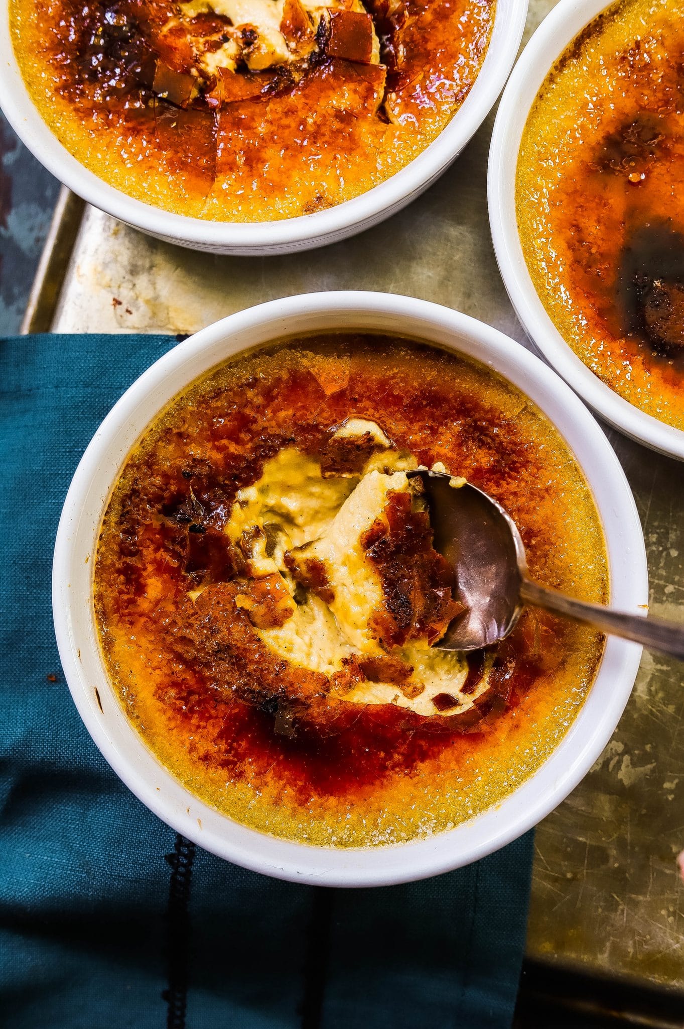 pumpkin creme brulee with the top cracked through using a spoon 