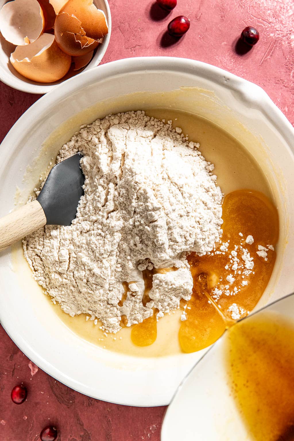 flour and brown butter being added. to the wet cake ingredients