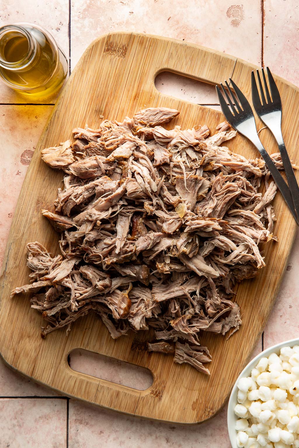 Pork shoulder after shredding on a cutting board