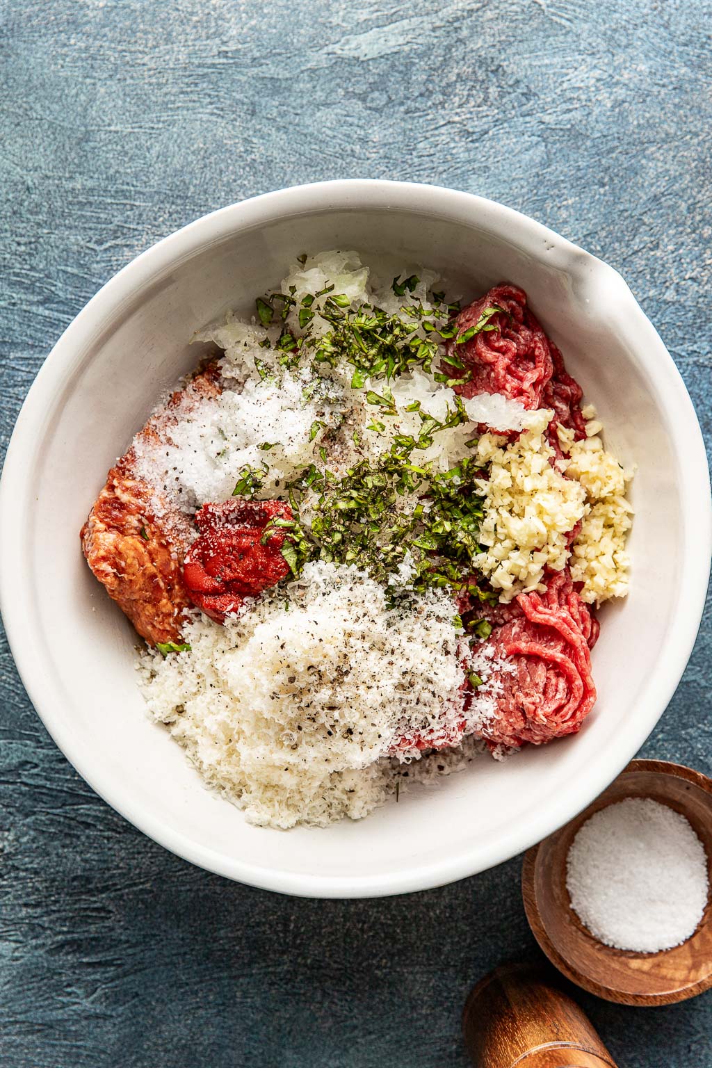 meatball ingredients in a white mixing bowl