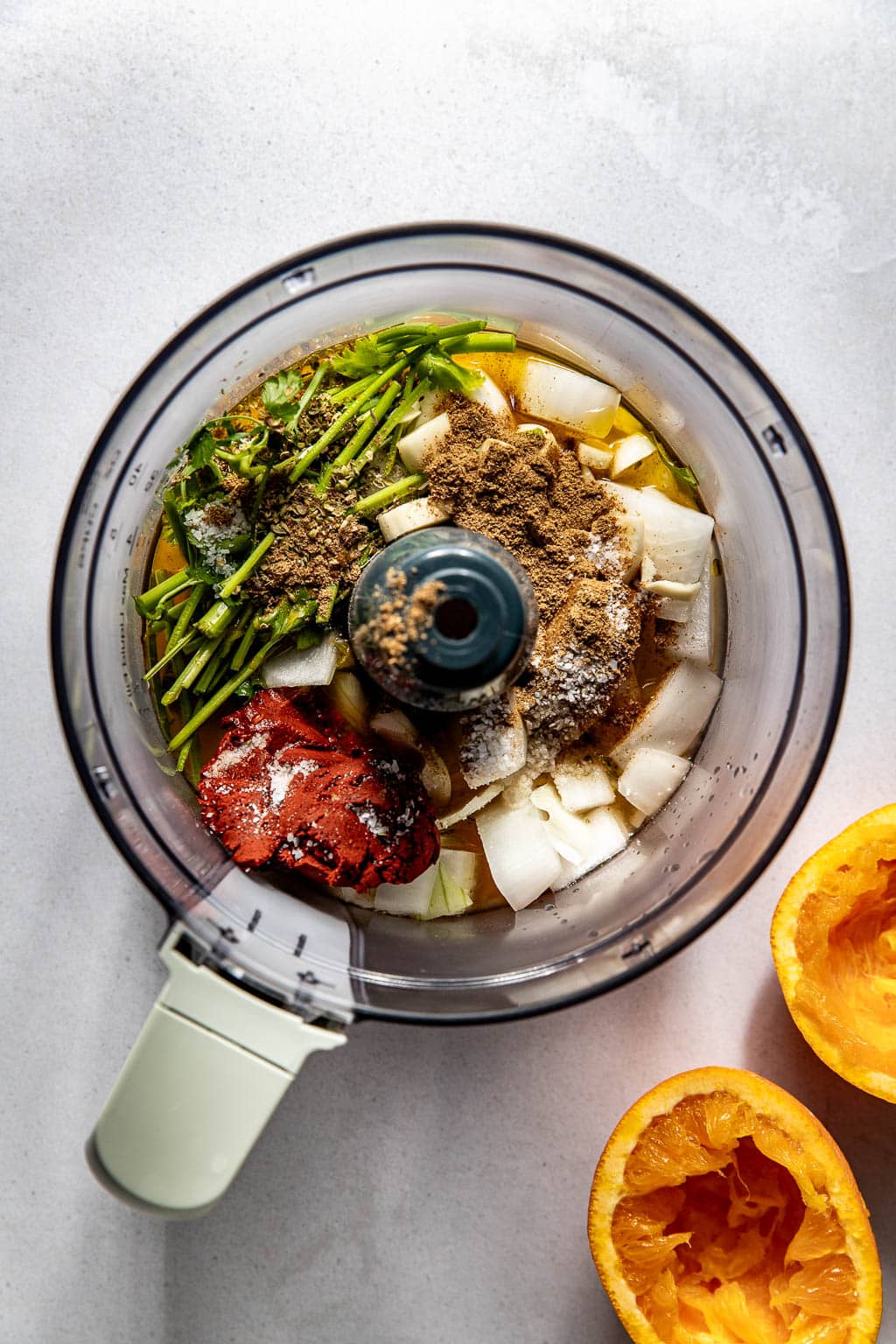ingredients for the pollo asado marinade in a food processor bowl