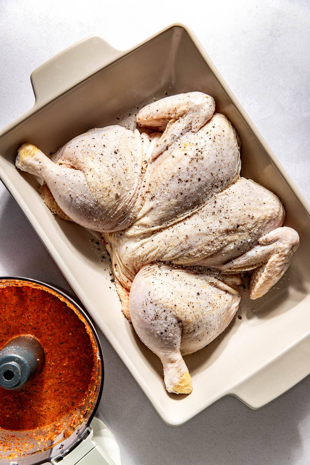 spatchcocked chicken sitting in a baking dish