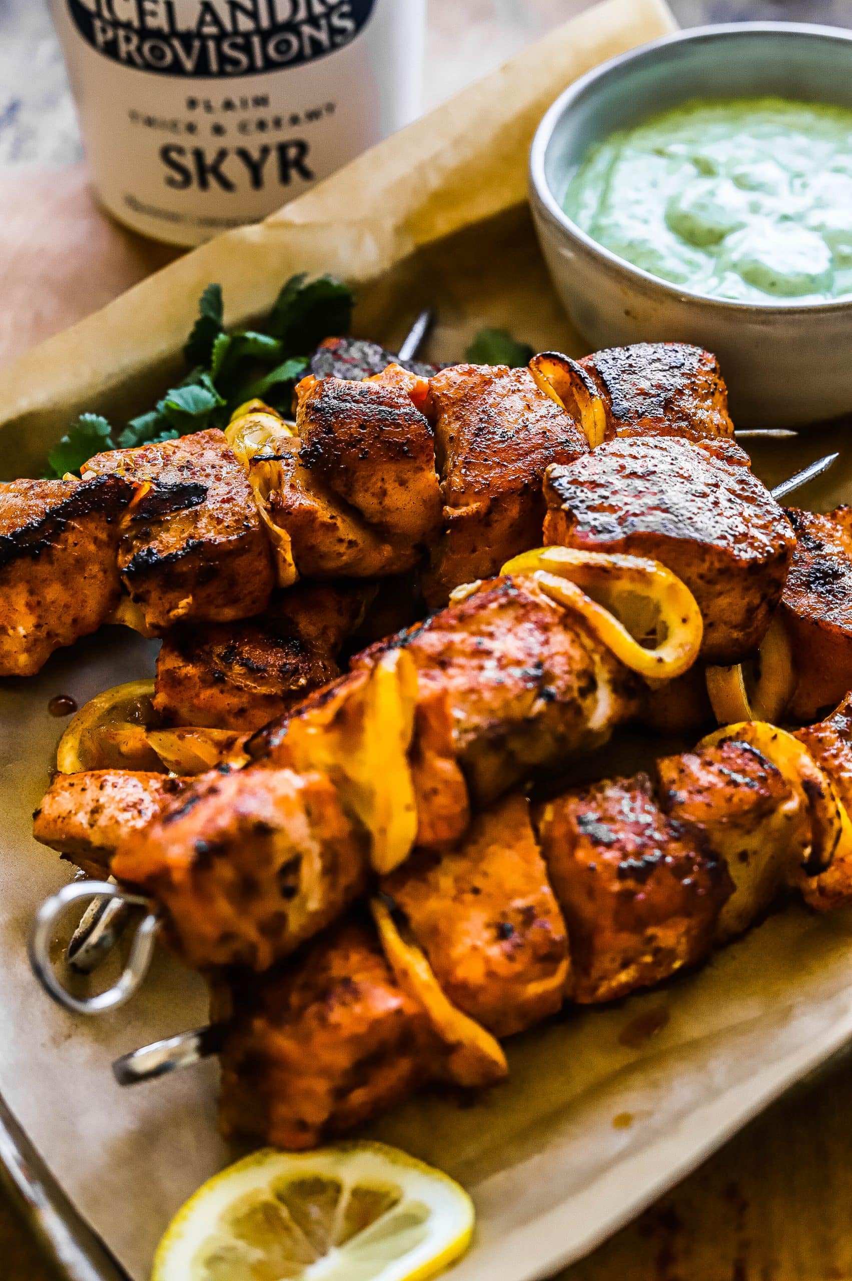 grilled salmon skewers on a tray 
