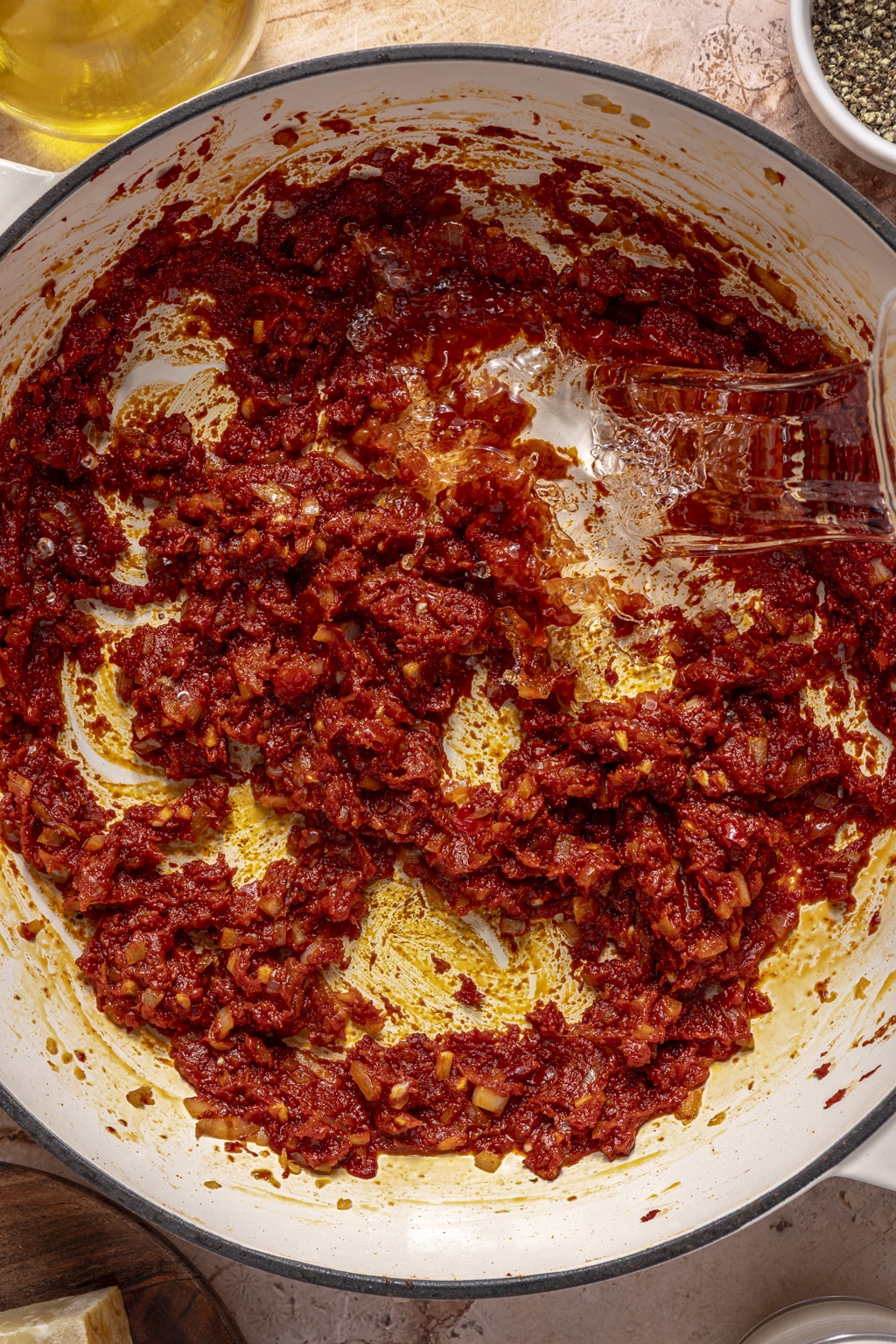overhead shot of pouring vodka into the dutch oven