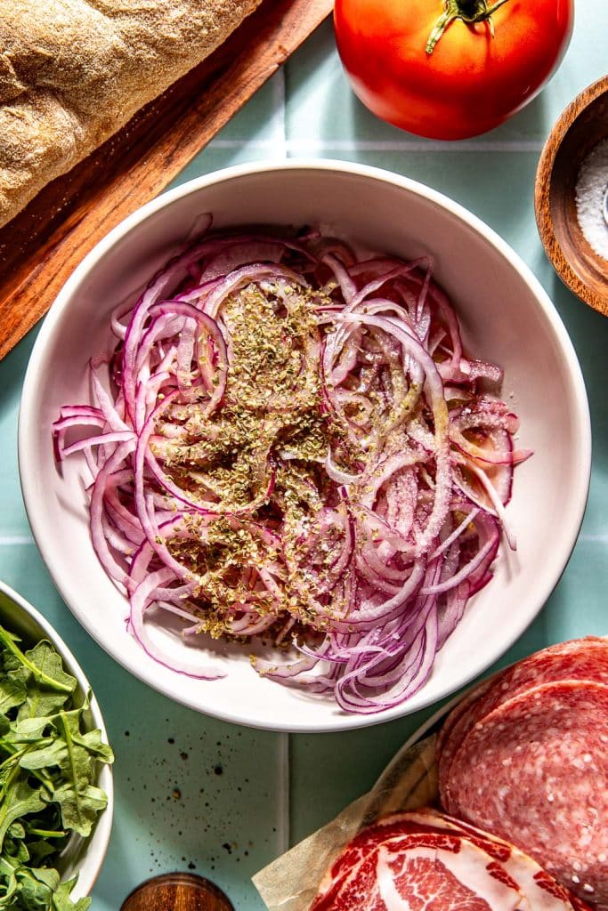 onions in a bowl with marinating seasonings