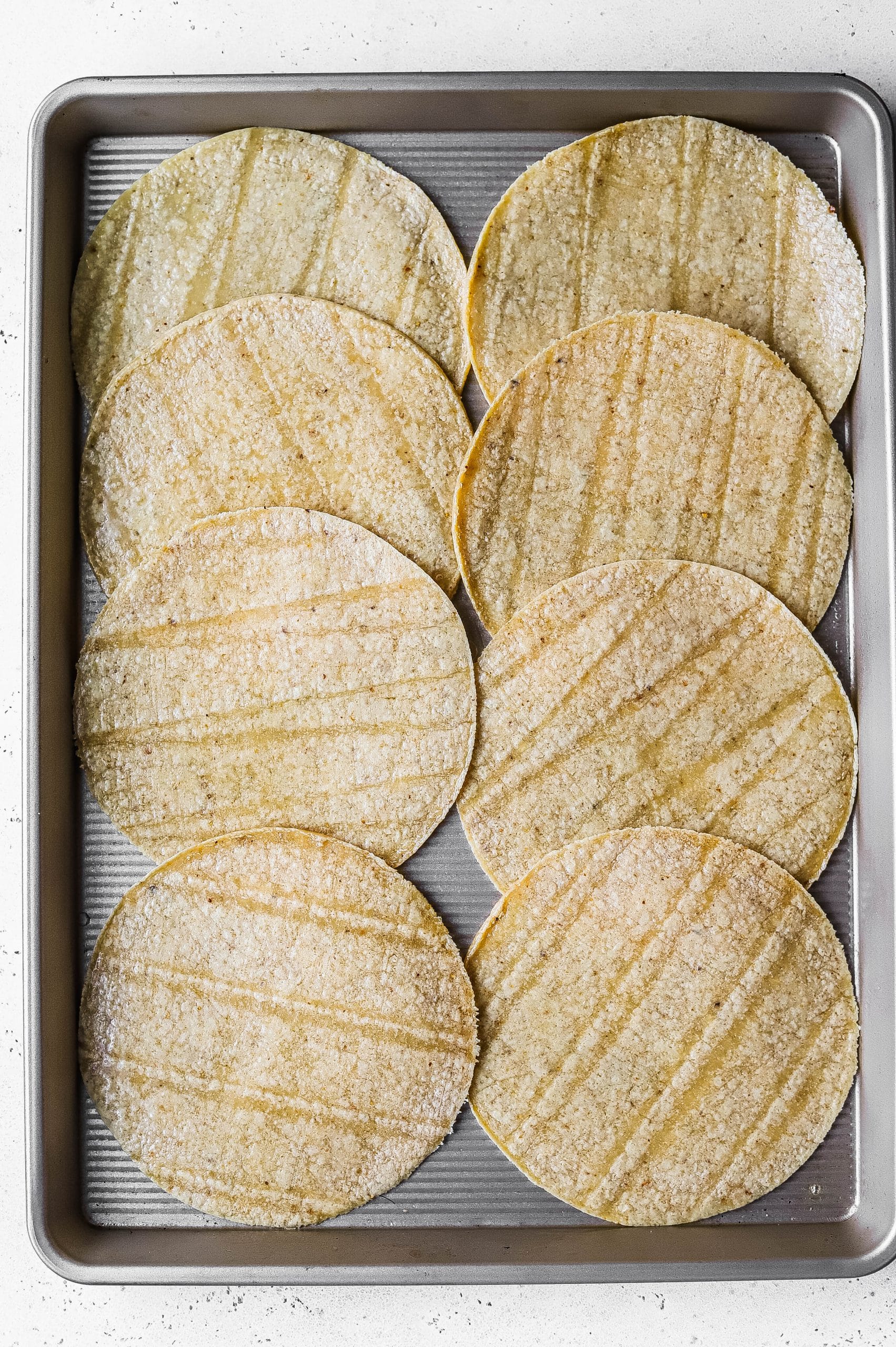 corn tortillas on a sheet pan