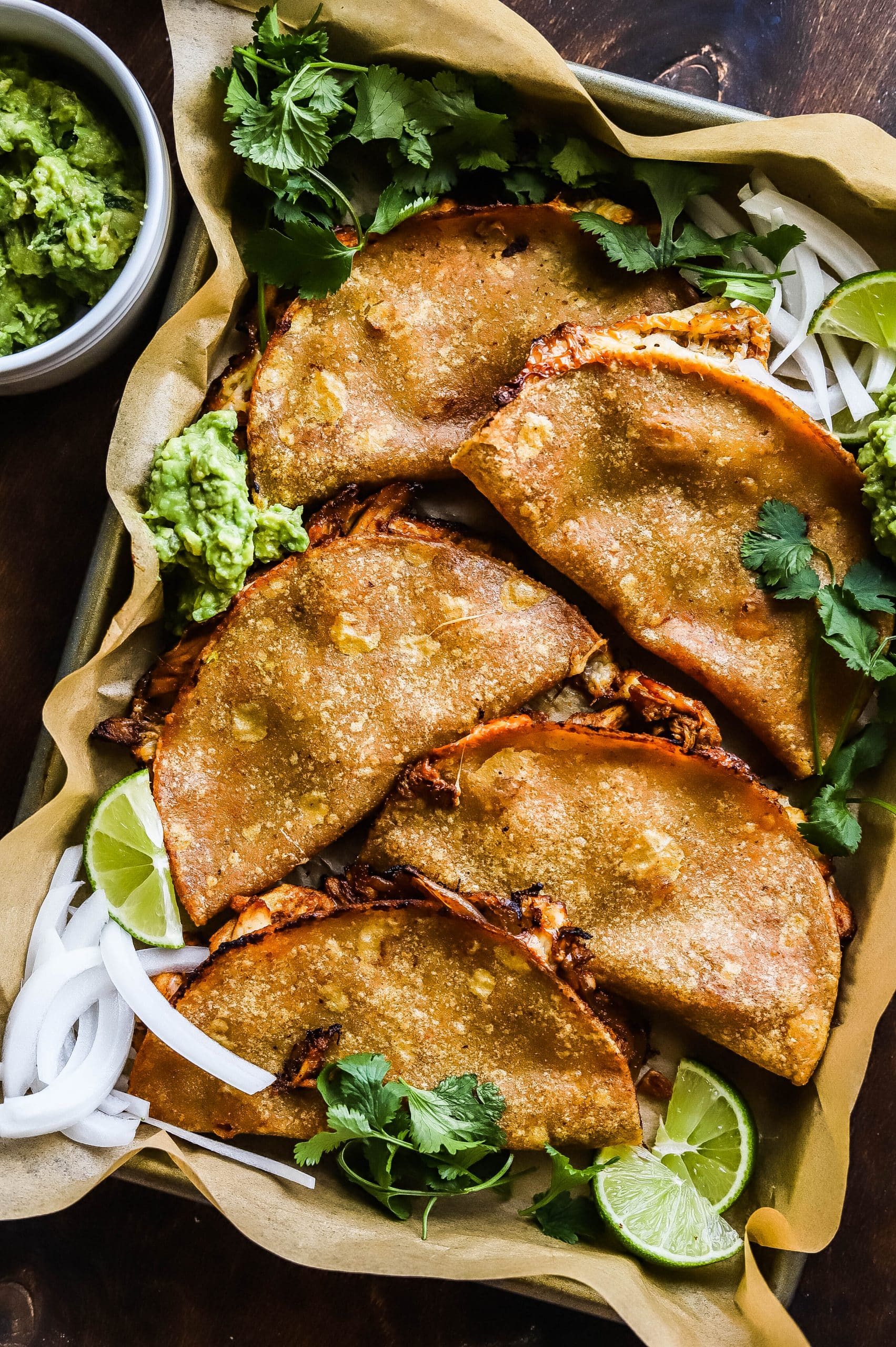 crispy baked chicken tacos on a sheet pan