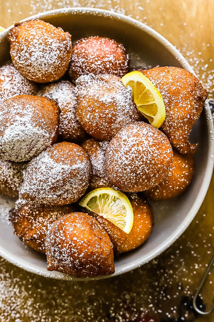 fried lemon fritters in a bowl