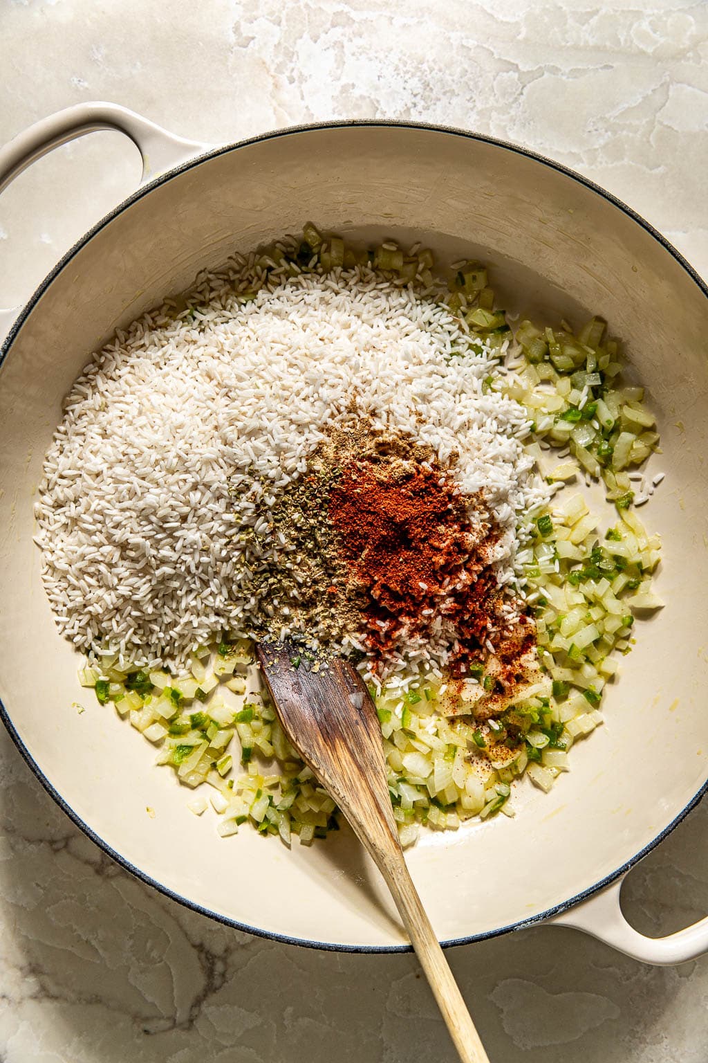 rice, spices, and veggies in a pan