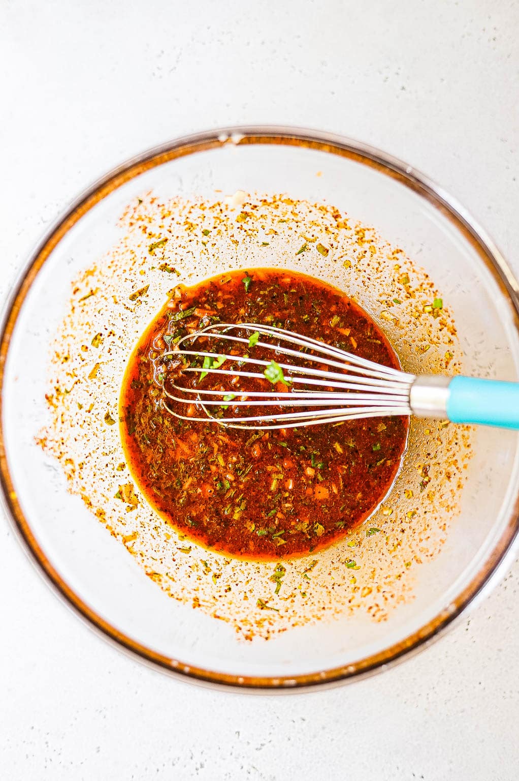 Carne asada marinade in a bowl with whisk 