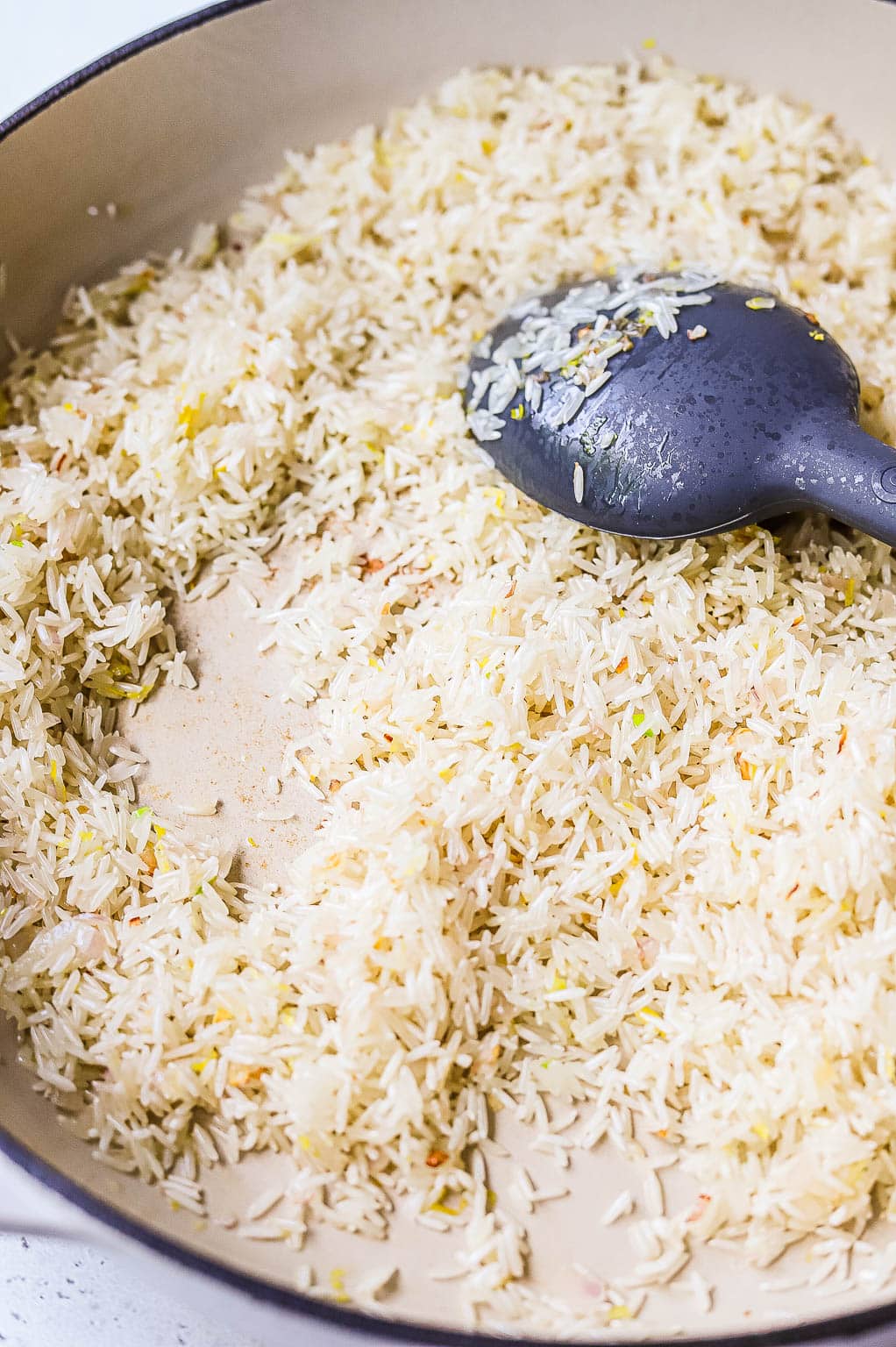 Basmati rice being toasted in a skillet 