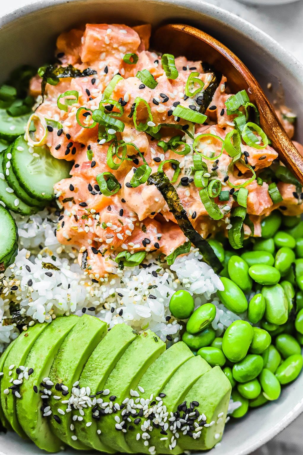 a salmon sushi bowl with edamame, avocado, and cucumber 