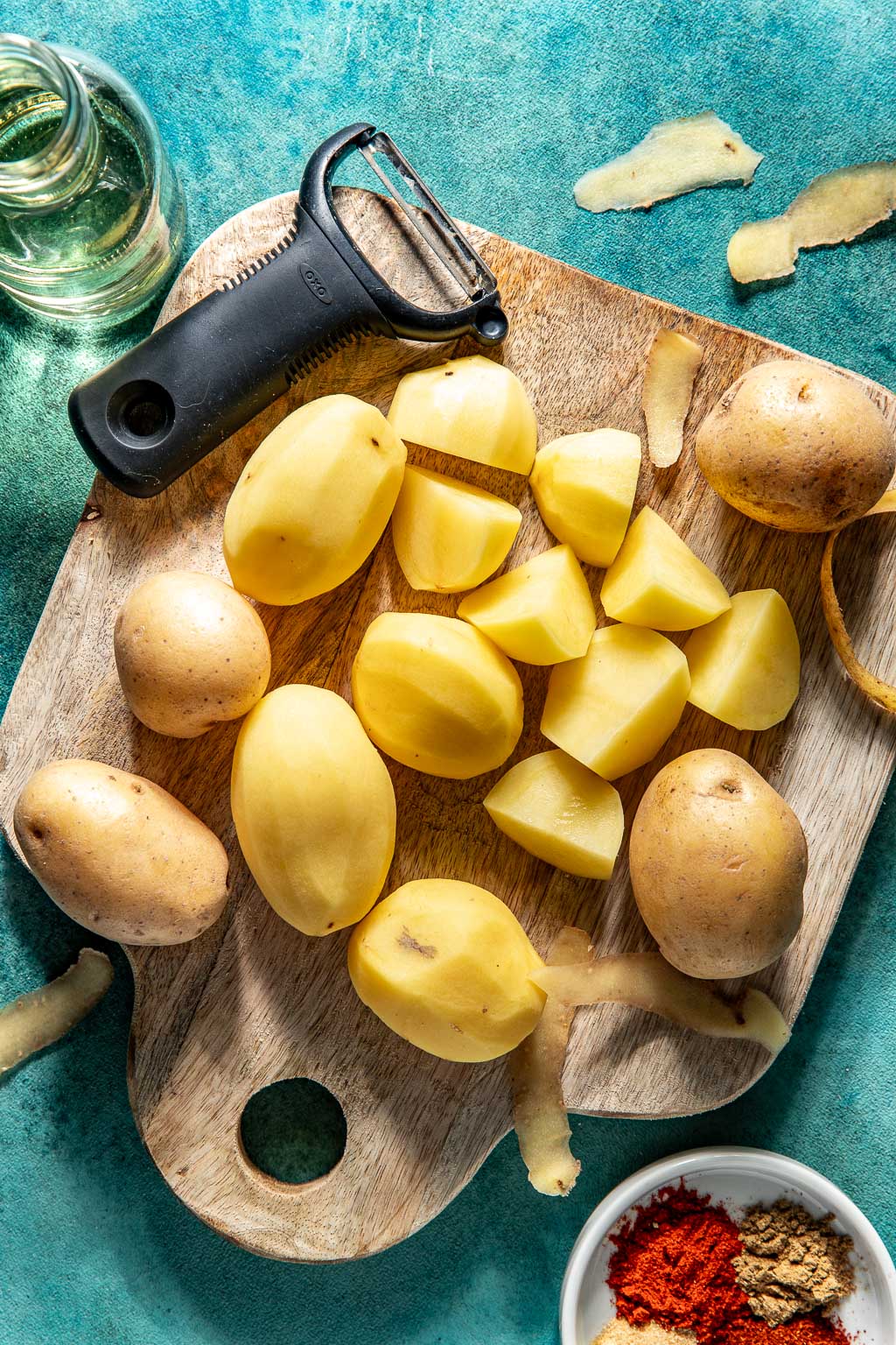peeled potatoes on a cutting board