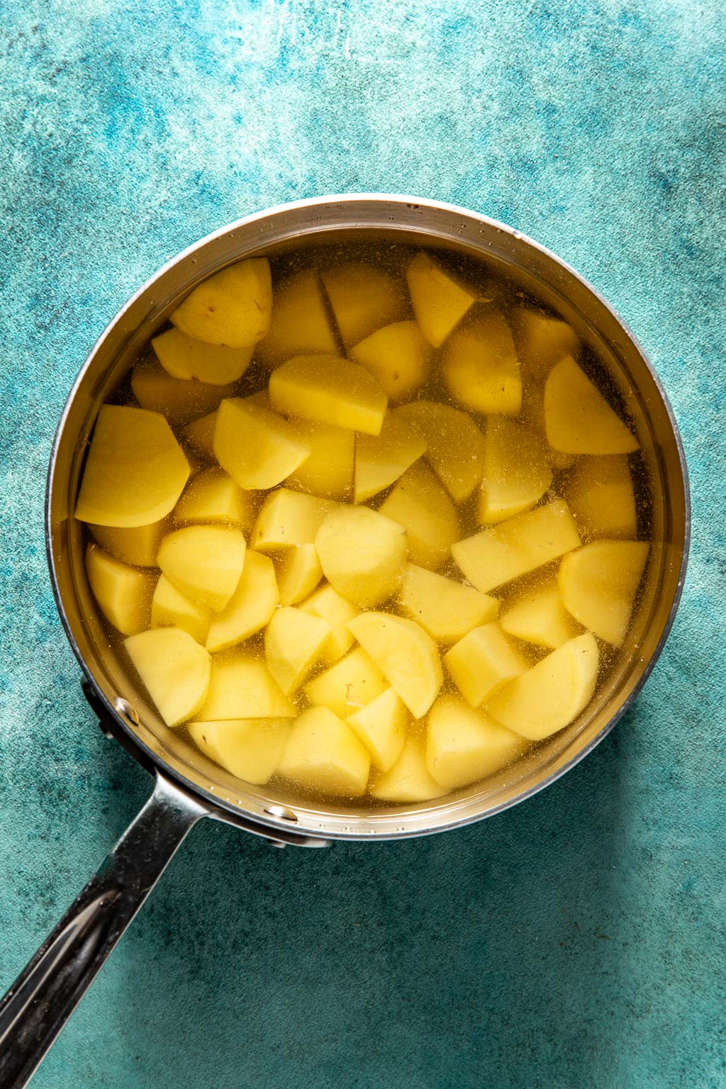potatoes in a pot of water before cooking