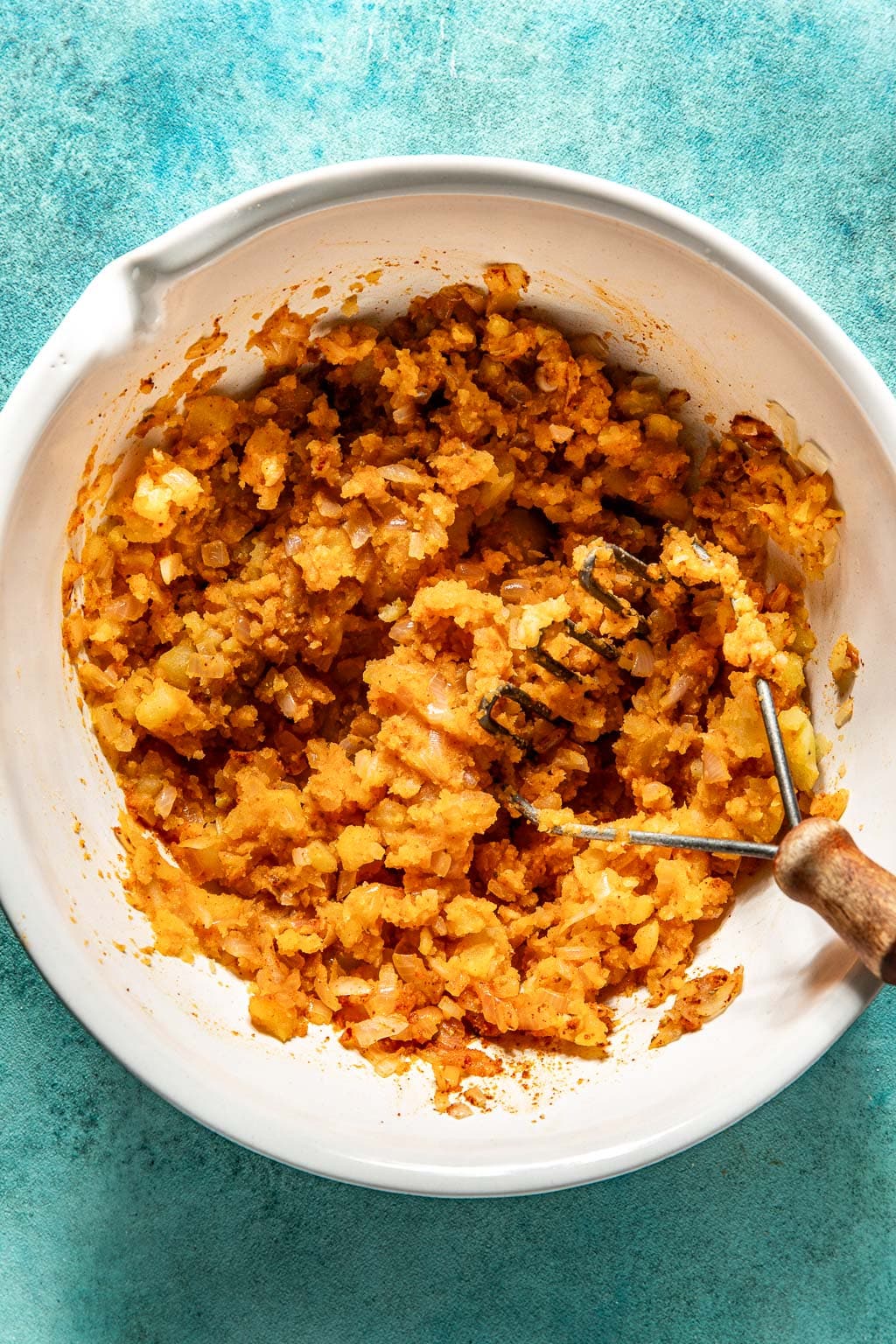 mashed potato filling for potato tacos in a mixing bowl