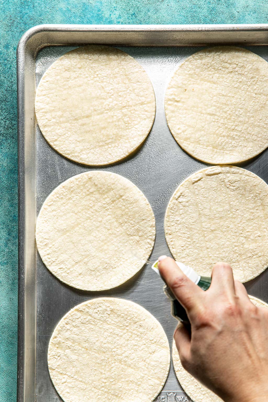 tortillas on a baking sheet before warming